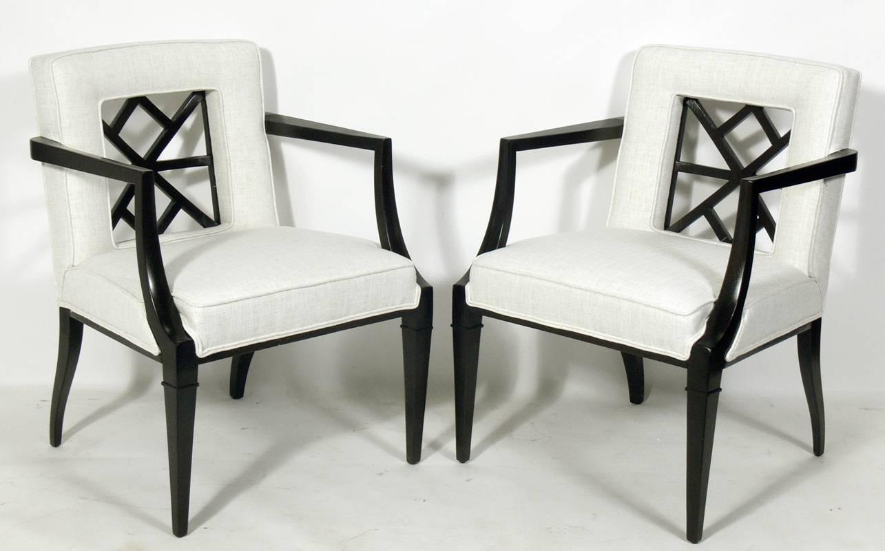 Pair of elegant fret back chairs, attributed to Grosfeld House, American, circa 1940s. They have been completely restored in an ivory herringbone fabric and the mahogany frames have been refinished in an ultra-deep brown lacquer.