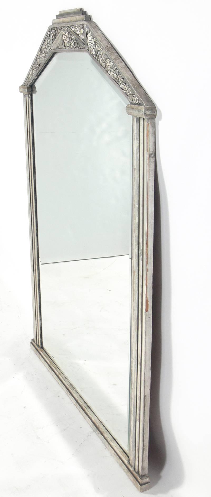 Art Deco silver leaf mirror, French, circa 1930s. Constructed in silver leafed wood and gesso. Retains warm original patina to both the silver leafed frame and the original beveled mirrored glass.
