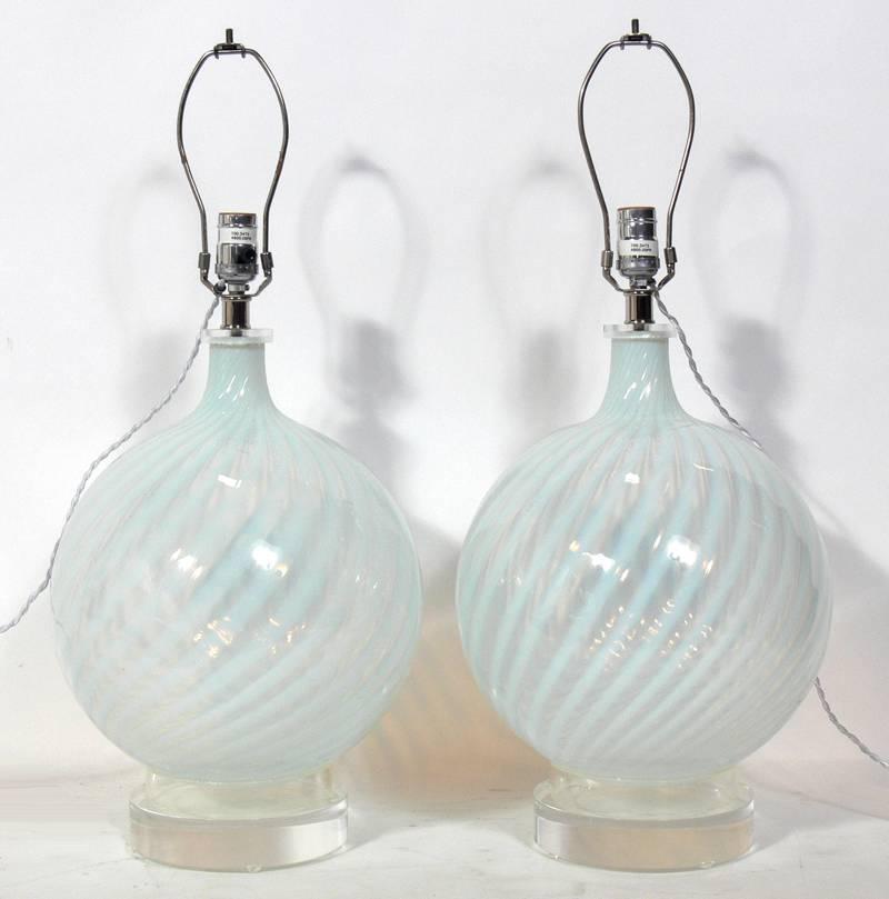 Pair of Murano glass lamps with Lucite bases, American, circa 1990s.
Executed in white and clear swirled glass with Lucite fittings and bases. The price noted includes the shades.