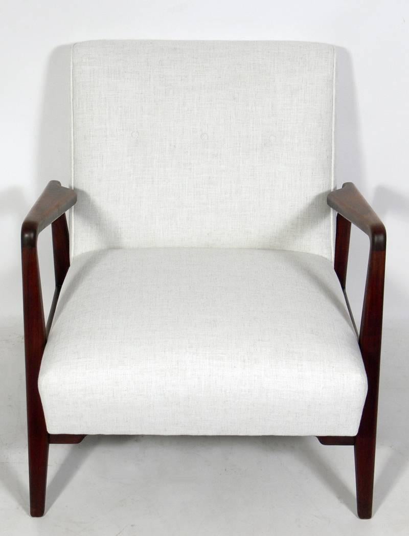 Mid-Century Modern walnut lounge chair by Jens Risom, American, circa 1960s. The walnut frame retains it's warm original finish and has been cleaned and hand rubbed with teak oil, and the chair has been reupholstered in an ivory color herringbone