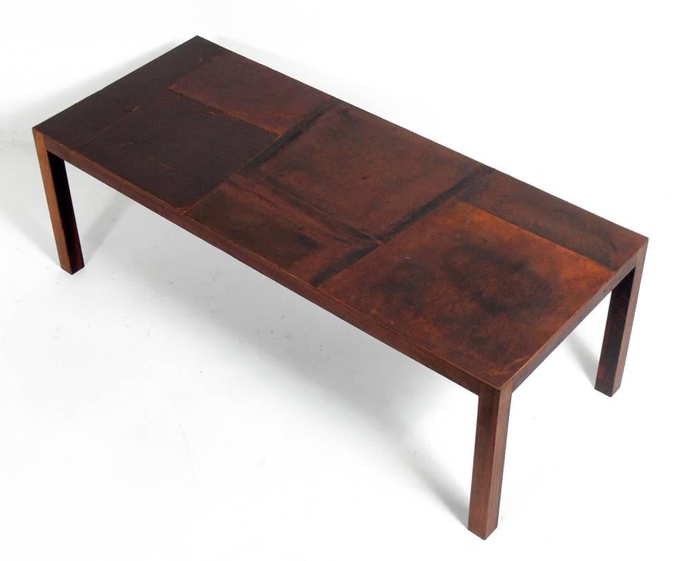 Danish modern rosewood coffee table with patinated leather top, Denmark, circa 1960s. Beautiful patchwork leather top retains warm original patina.
