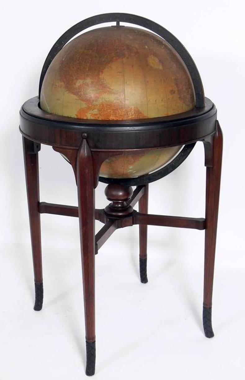 French Art Deco style globe, made by Rand McNally, American, circa late 1920s-1930s. The globe itself retains a warm original patina. The frame is currently being refinished in its original color. This piece stands an impressive forty inch height
