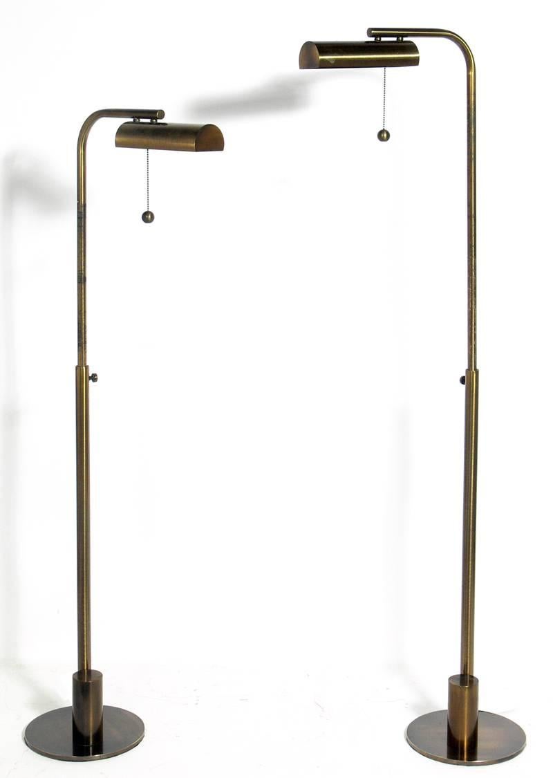 Pair of patinated brass floor lamps by Charles Hollis Jones, American, circa 1970s. This design was originally created by Hollis Jones for Lucille Ball and became one of his favorite production designs. They have an adjustable height from - 57.75