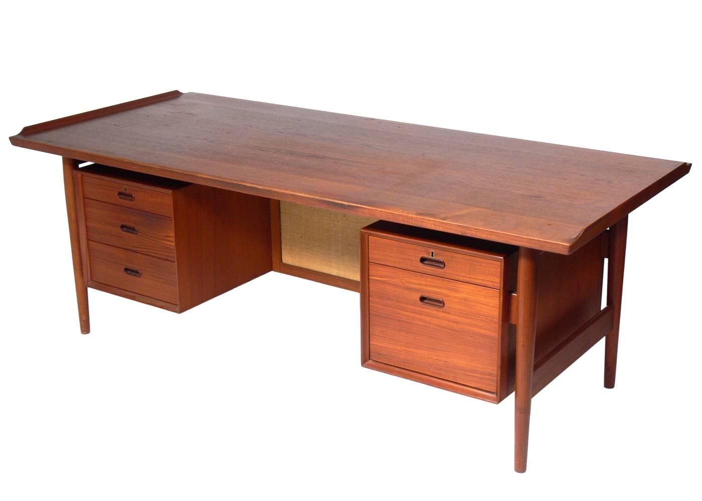 Danish Modern teak desk and chair, designed by Arne Vodder for Sibast, Denmark, circa 1960s. The desk is in very good condition. We are refinishing the top of the desk, and the base of the desk and the chair have been cleaned and teak oiled. The