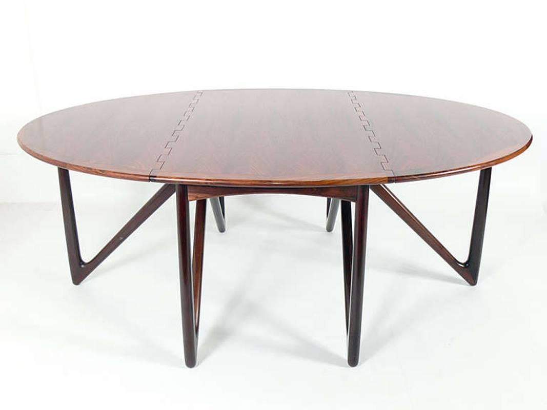 Oval rosewood dining table by Kurt Ostervig, Danish, circa 1960s. Spectacular rosewood graining. The table measures an impressive 76.75