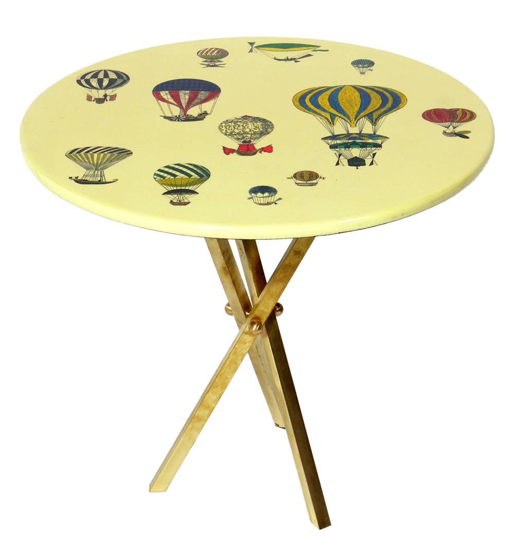Elegant brass tripod table, designed by Piero Fornasetti, Italy, circa 1950s. This piece is a versatile size and can be used as a drinks table between a pair of chairs, or as a side or end table, or as a nightstand. The brass retains its warm