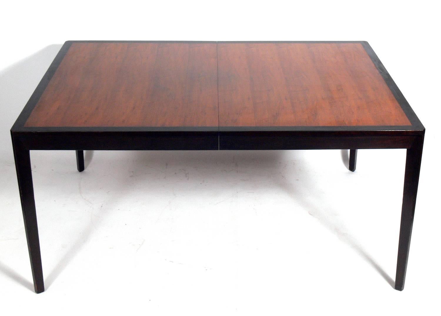 Clean lined dining table, designed by Edward Wormley for Dunbar, American, circa 1950s. Beautifully grained top. This piece is currently being refinished and can be completed in your choice of color.
Without any leaves, the table seats six guests