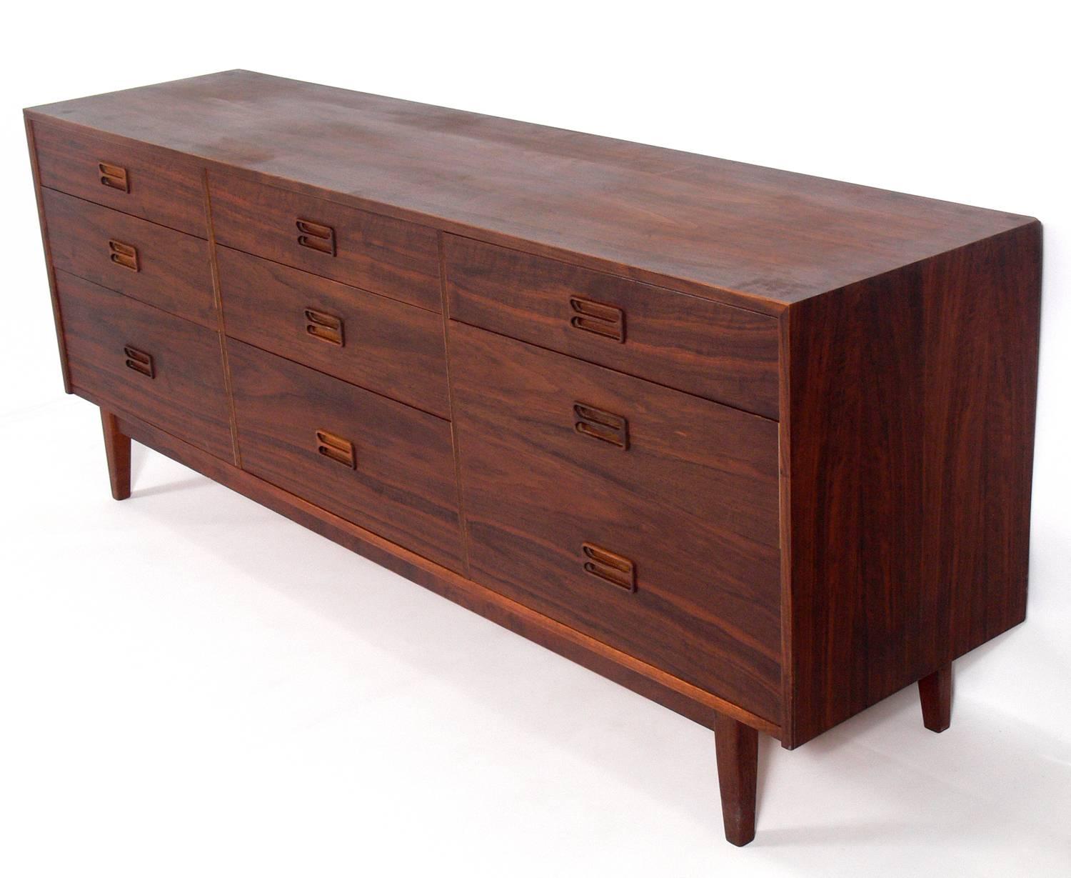 Danish modern walnut chest or dresser with beautiful graining, Denmark, circa 1960s. This piece is currently being refinished and will look incredible when it's completed. This piece is a versatile size and can be used as a chest or dresser in a