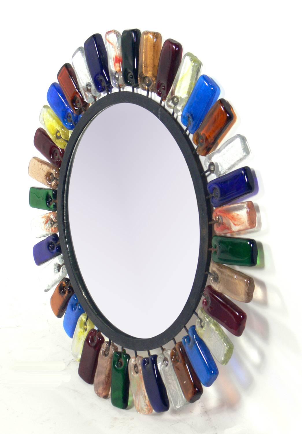 Colorful handmade glass and iron mirror attributed to Feders, Mexico, circa 1960s. This mirror would look great anywhere you need a graphic pop of color!