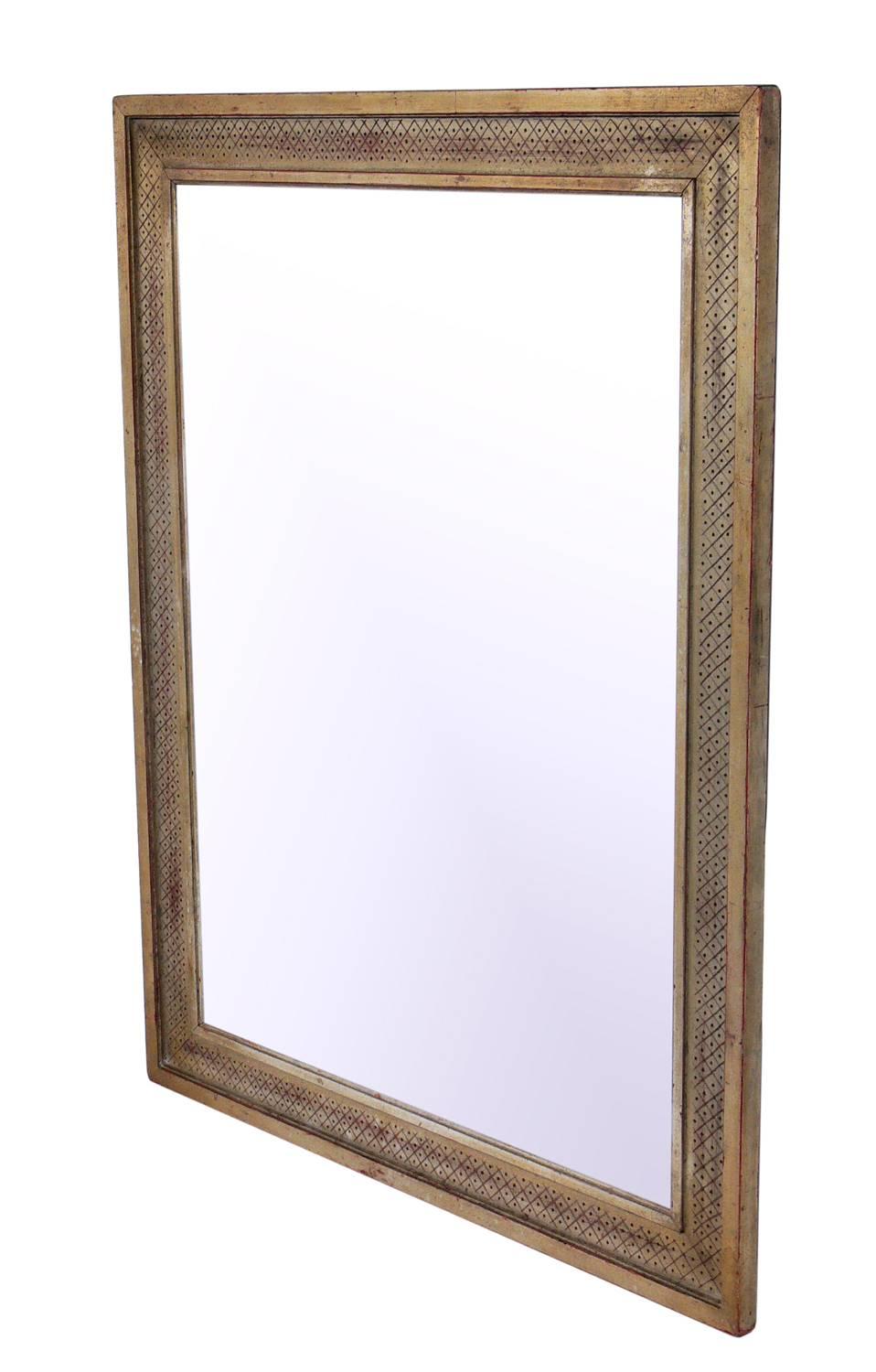 Elegant silver leaf mirror in the manner of Max Kuehne, American, circa 1930s. The silver leafed wood frame retains it's wonderful original patina. The mirrored glass has been replaced at some point.