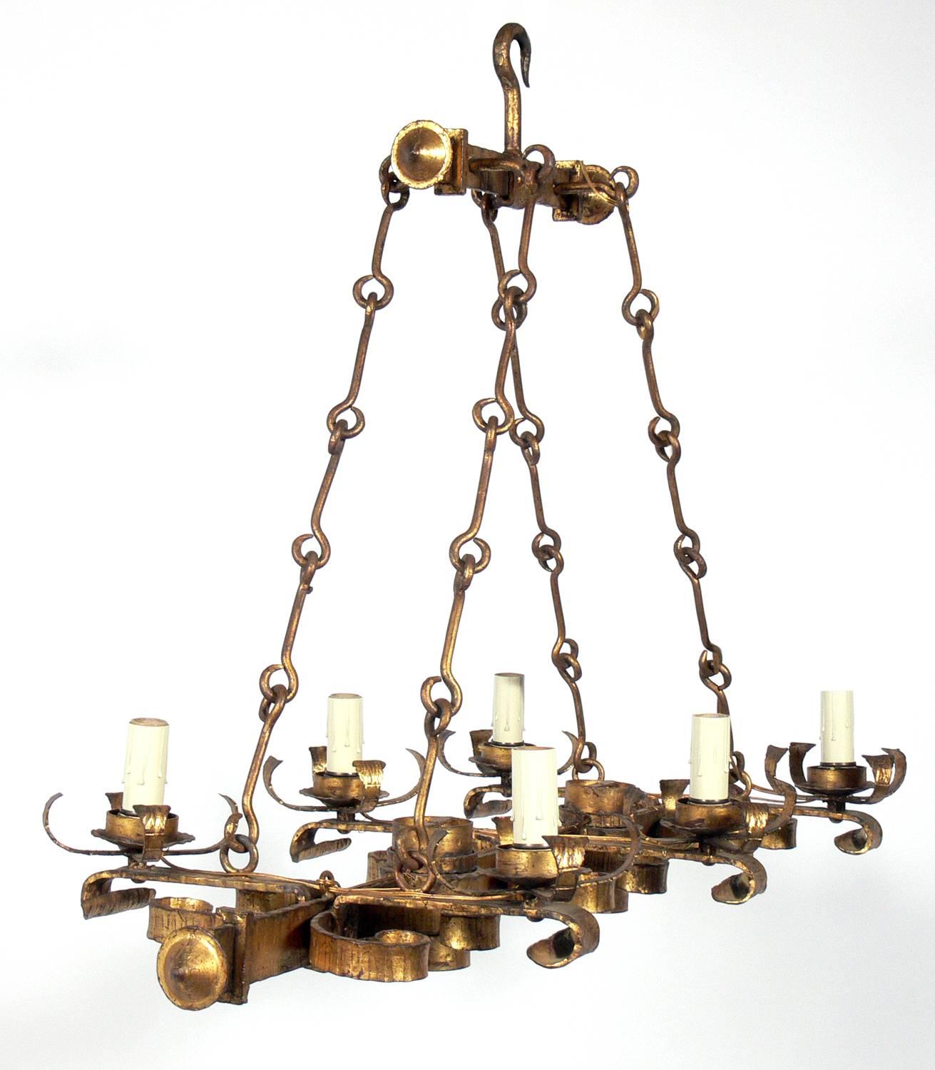 Elegant gilt iron chandelier, Spain, circa 1950s. This hanging chandelier has an elegant design and is very high quality, heavyweight construction. It has two down lights and four up lights. It has been rewired and is ready to use.