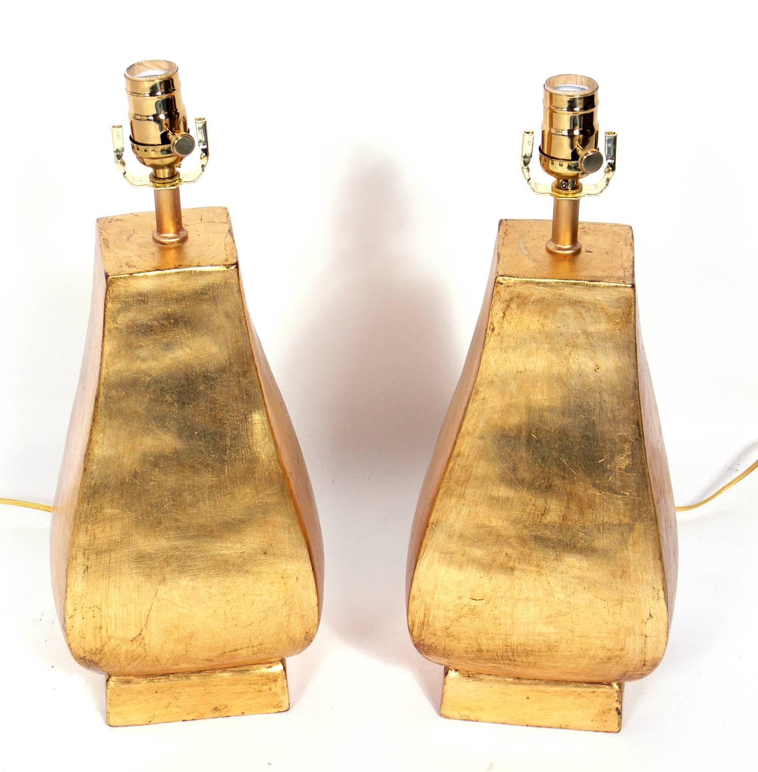 Pair of gilt terracotta lamps, handmade by Ugo Zaccagnini, Italian, circa 1950s. Signed with the artist's monogram underneath. The price noted in this listing includes the pair of lamps and shades.