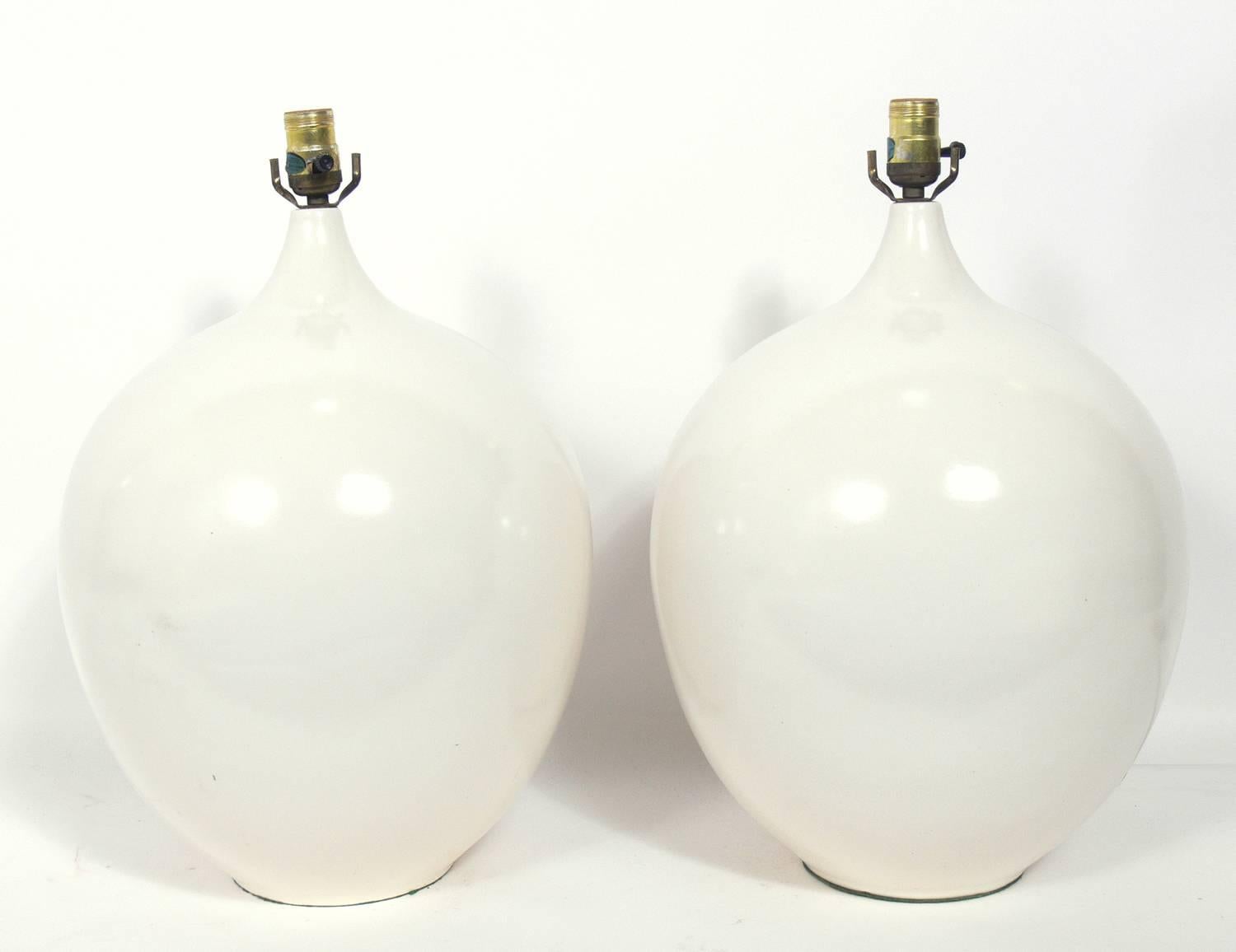 Pair of sculptural white ceramic lamps, American, circa 1960s. Rewired and ready to use. The price noted includes the shades.