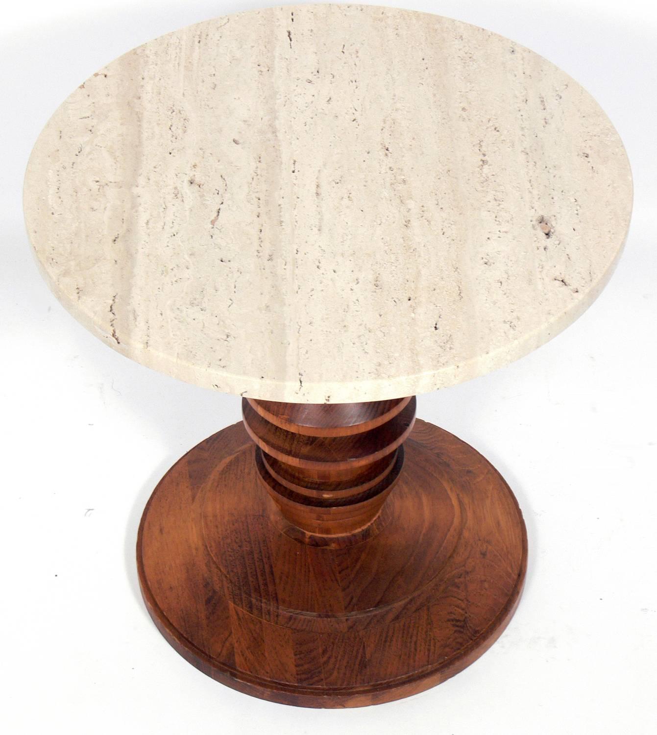 Mid-Century Modern travertine and walnut end or side table, American, circa 1950s. The walnut base of the table is very sculptural and is reminiscent of the 
