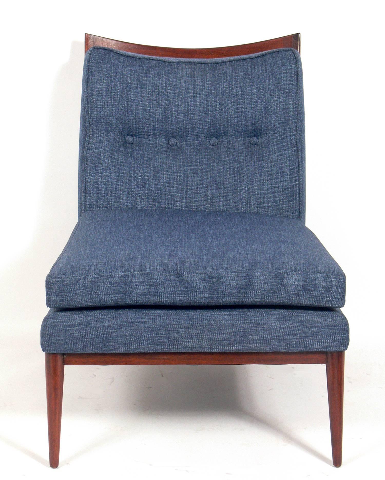 Modernist lounge chair, designed by Paul McCobb, circa 1950s. It has been reupholstered in a ocean blue color linen style fabric.