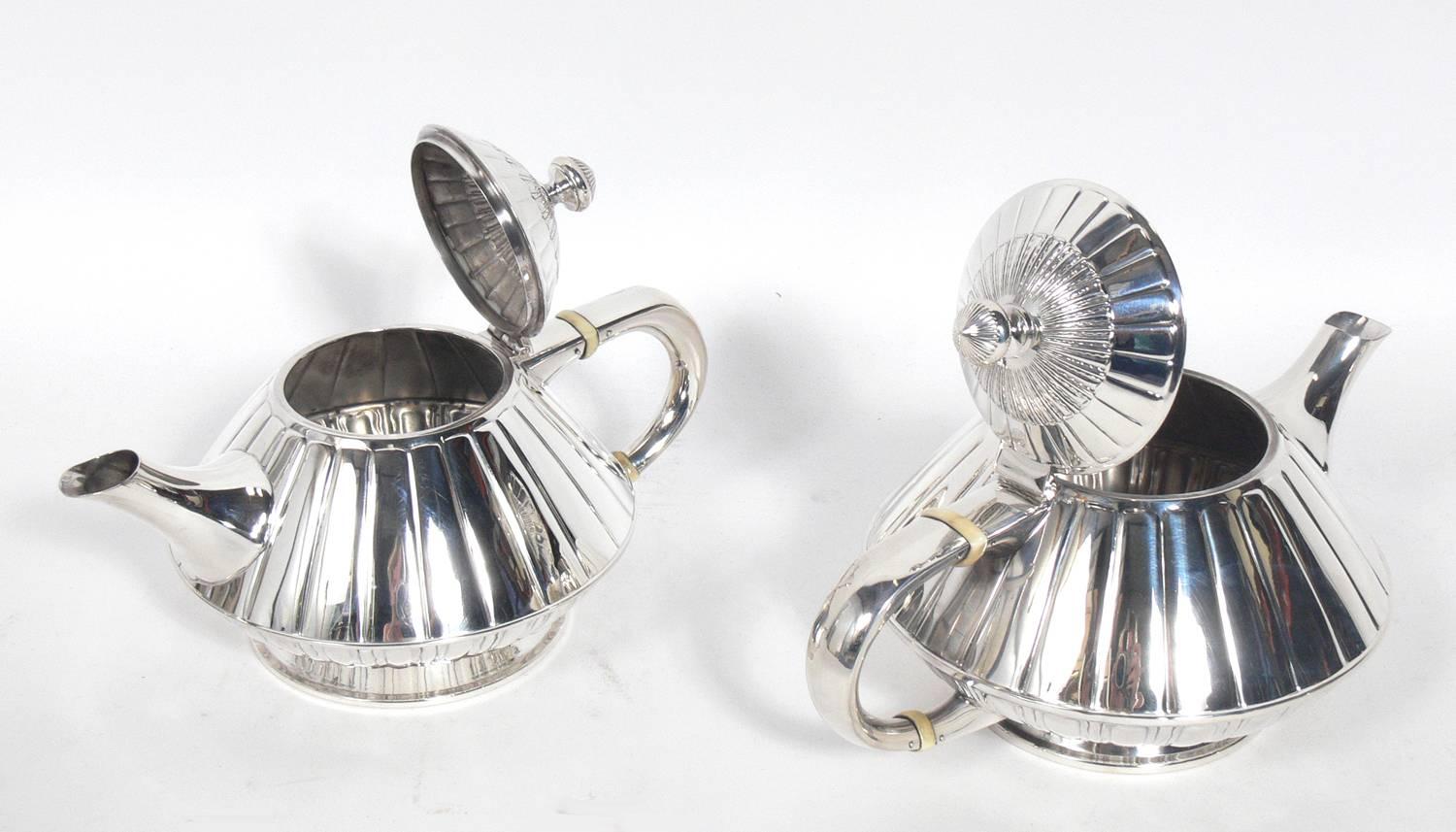 Rare Art Deco reed and Barton sterling silver tea or coffee set, American, circa 1930s. The larger tea pot measures 5.5