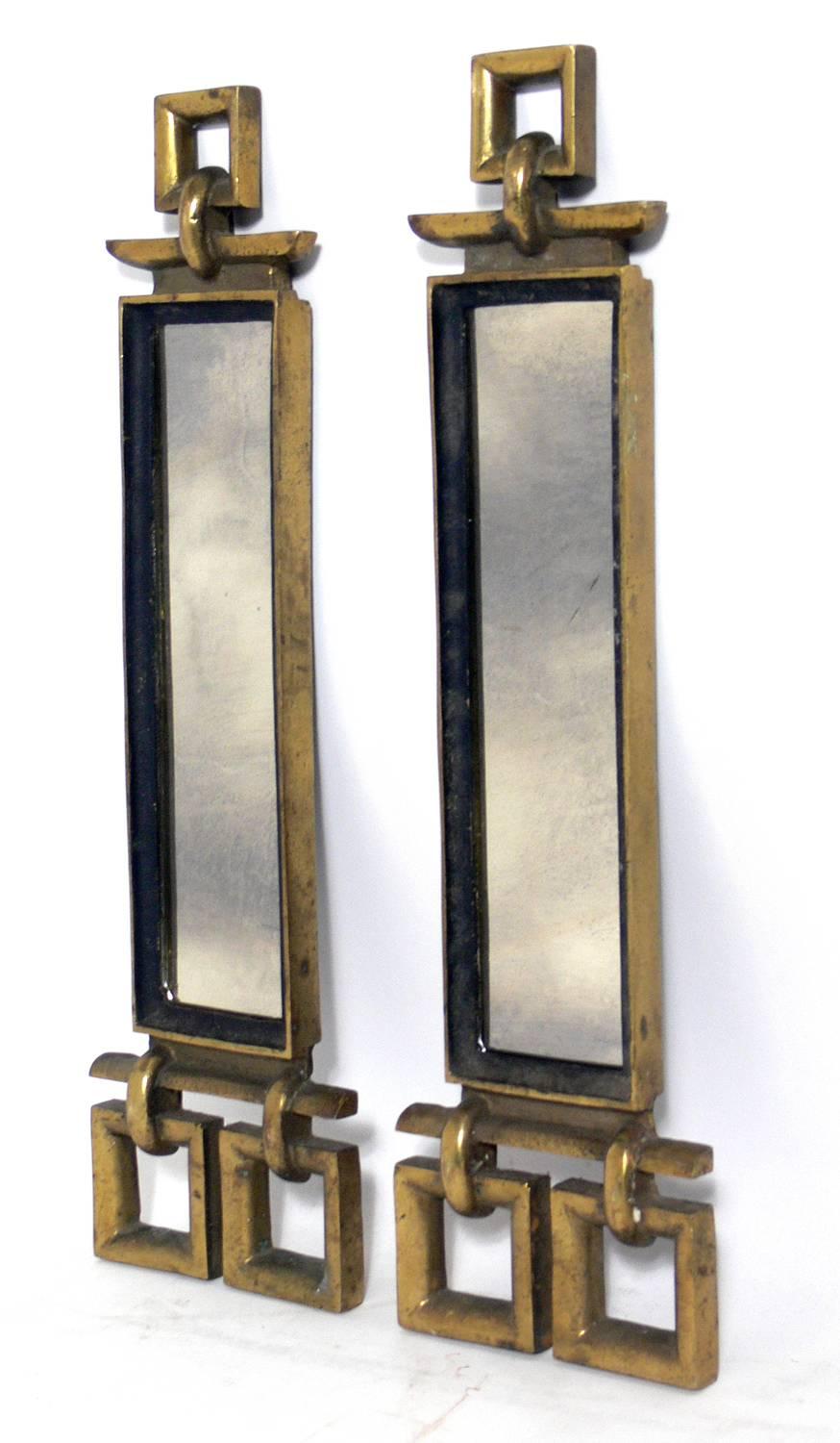 Elegant brass and antiqued mirror andirons, American, circa 1940s.