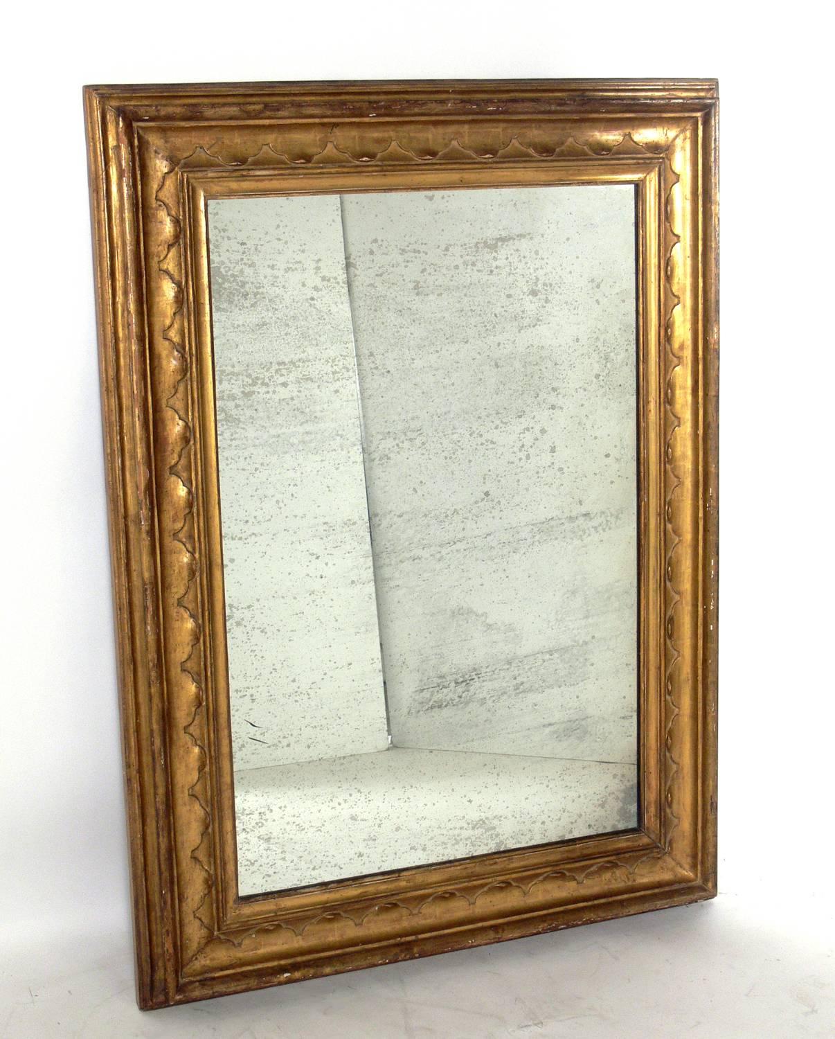 Large Scale 19th Century Gilt Mirror, probably American, circa early 1800s. Both the gilt frame and the mirrored glass retain a wonderful patina.
