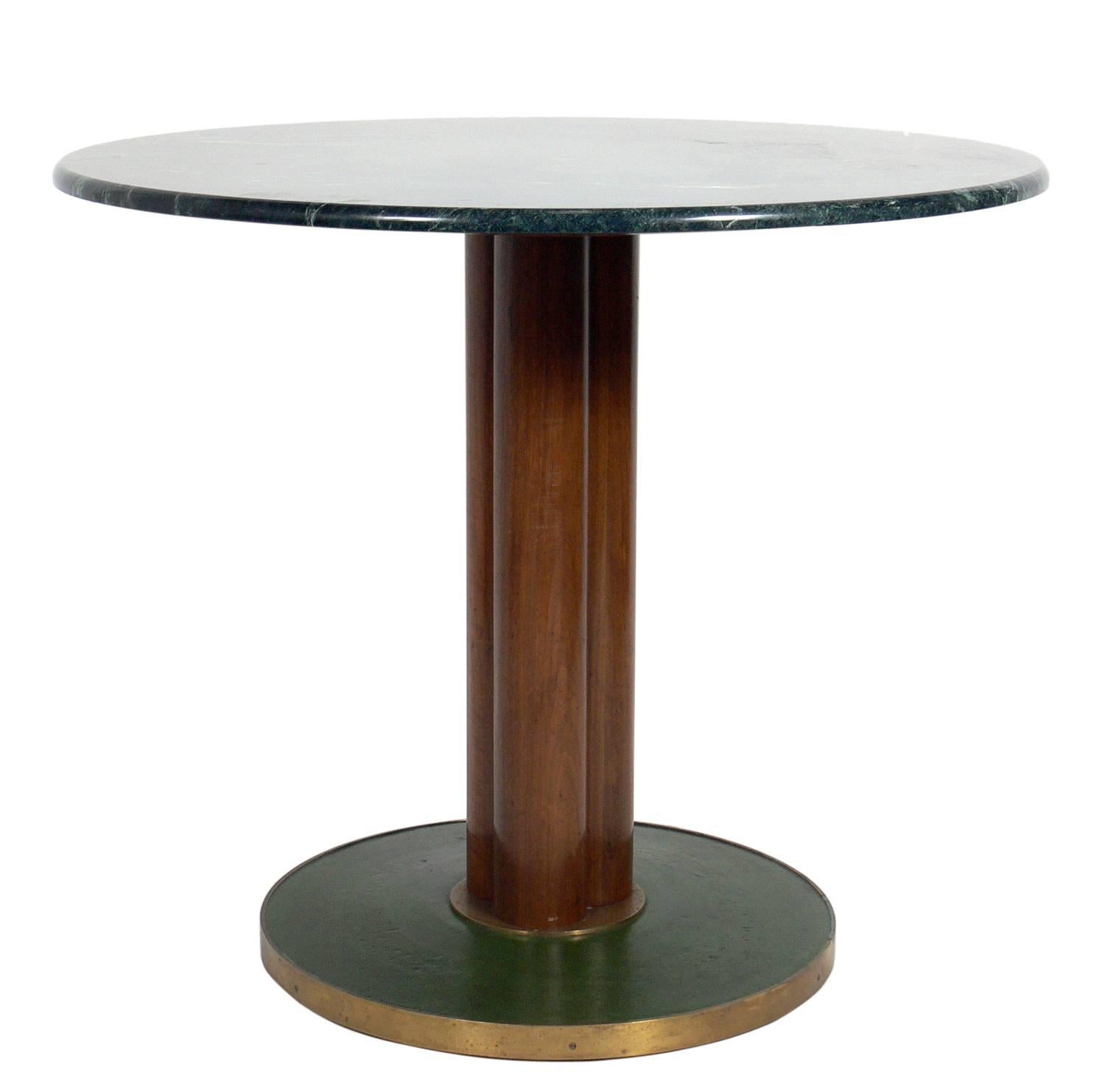 Rare and early marble-top table, designed by Edward Wormley for Dunbar, circa late 1940s. This is a versatile size and can be used as a dining table, game table, or centre table. It is constructed of marble, mahogany, leather and brass.