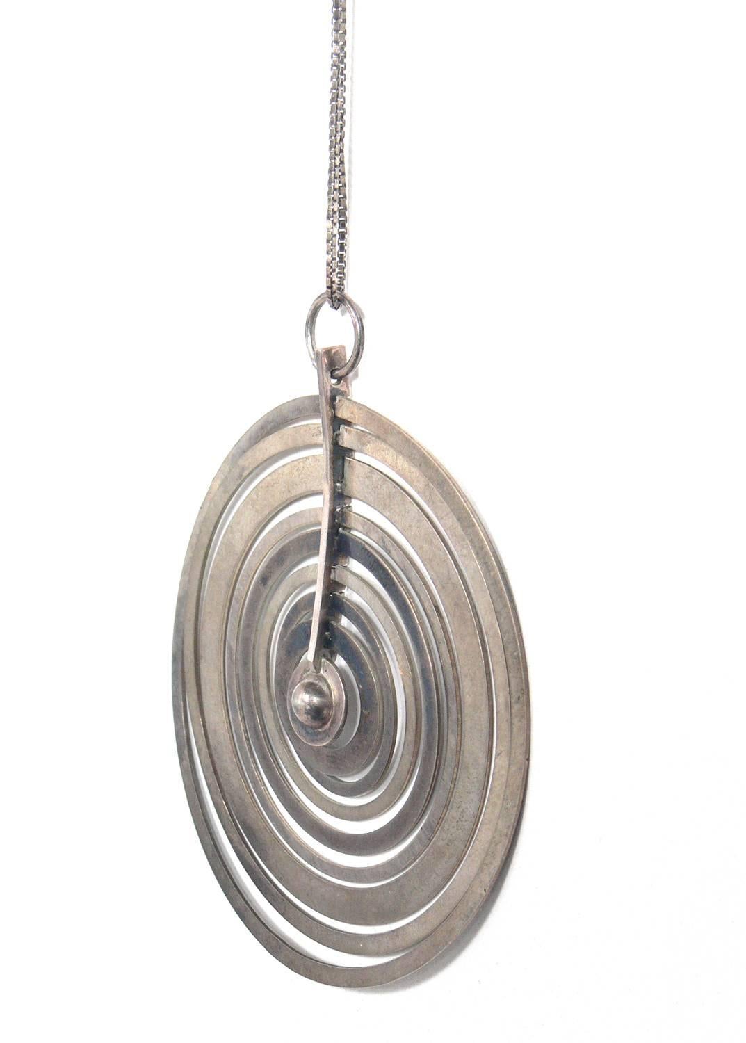 Sculptural sterling silver pendant necklace, designed by Tapio Wirkkala for Nils Westerback Oy, Finland, circa 1971. Signed with impressed manufacturer's mark and touchmarks to reverse: [NW 925H Assay Marks for Finland T7]. Literature: Tapio