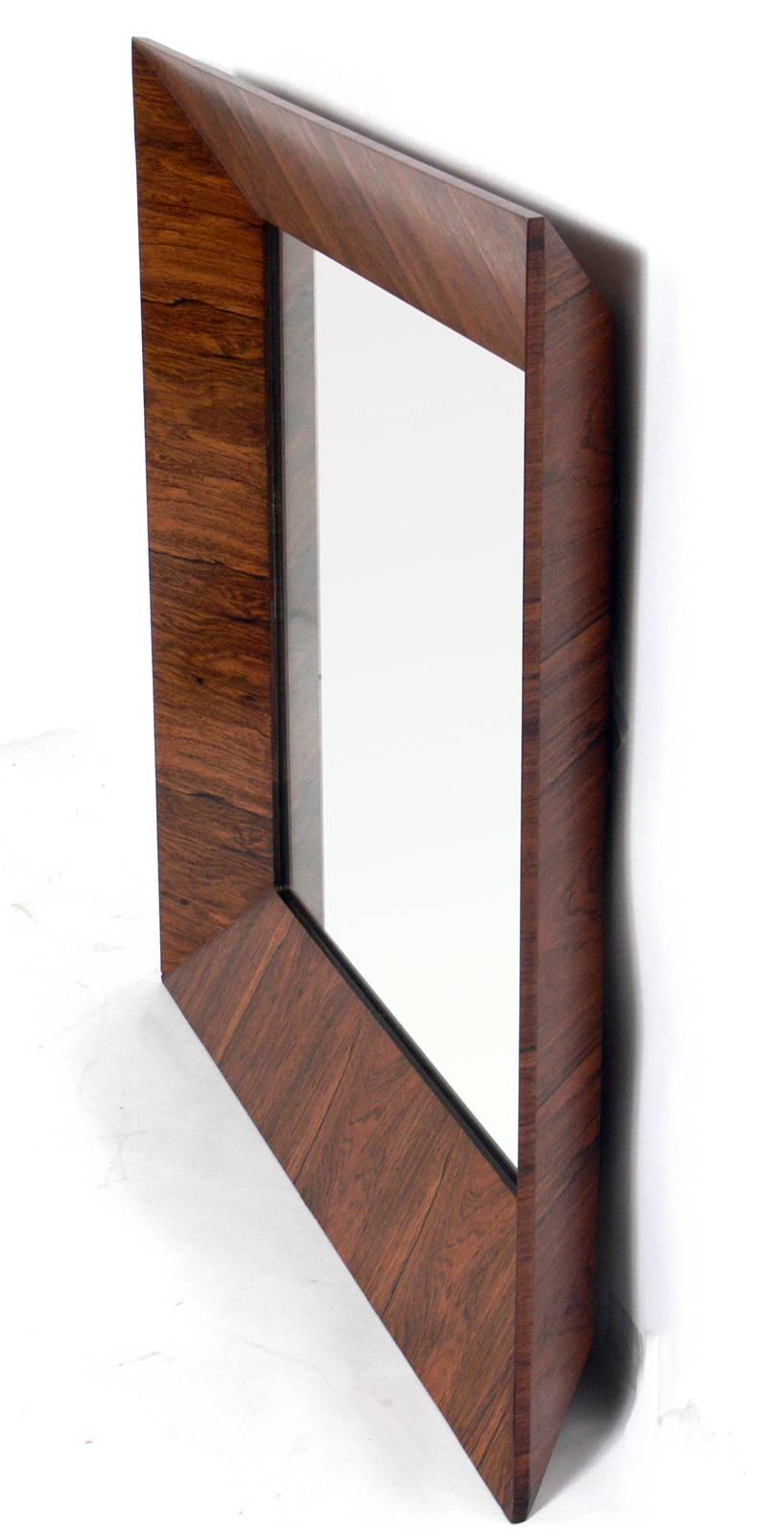 Rosewood mirror designed by Edward Wormley for Dunbar, American, circa 1950s. Crisp, deeply angled design. updated