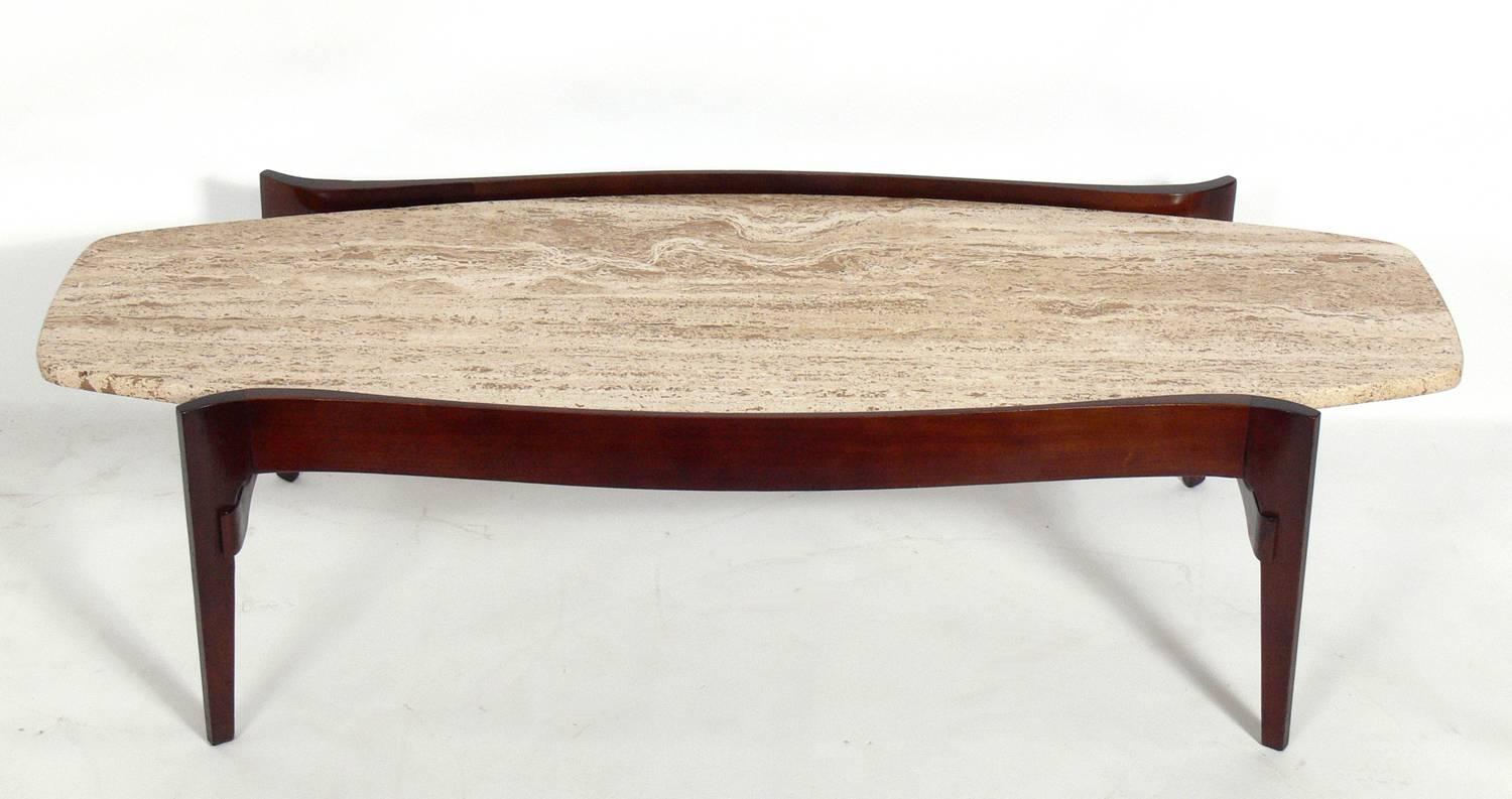 Sculptural Italian Modern coffee table, circa 1950s. Executed in walnut and the original travertine top.
 