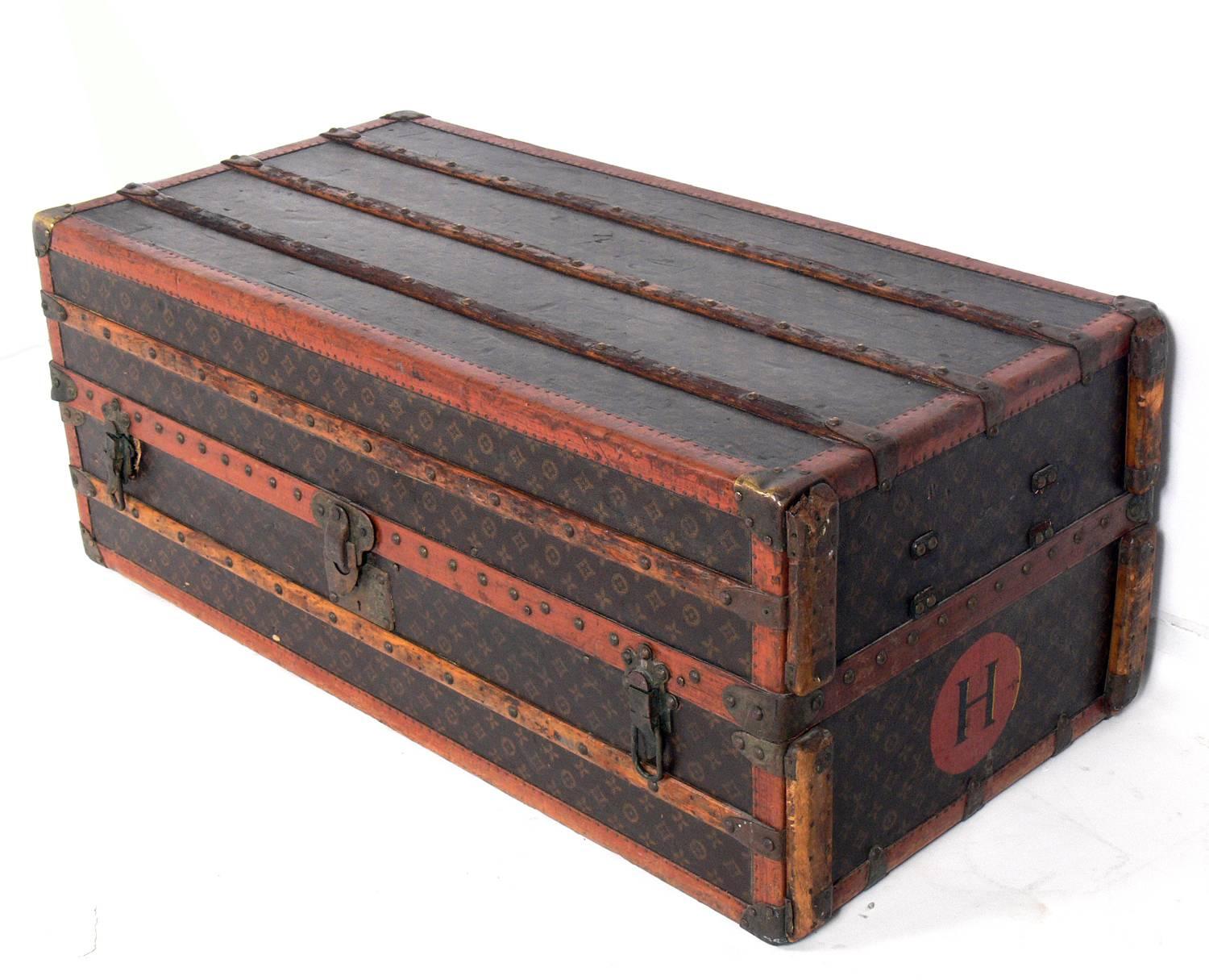 Louis Vuitton wardrobe trunk, Paris, France, circa 1930s or earlier. It is executed in the L. V. ‘Monogramme’ canvas, trimmed in brass, wood, and leather. Signed with original Vuitton impressed marks and labels throughout. The trunk retains it's
