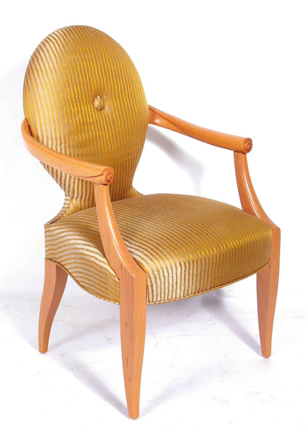 Elegant armchair designed by John Hutton for Donghia, circa 1990s. It would make a great desk or occasional chair. It is currently being reupholstered and can be completed in your fabric. The price noted below includes reupholstery in your fabric.