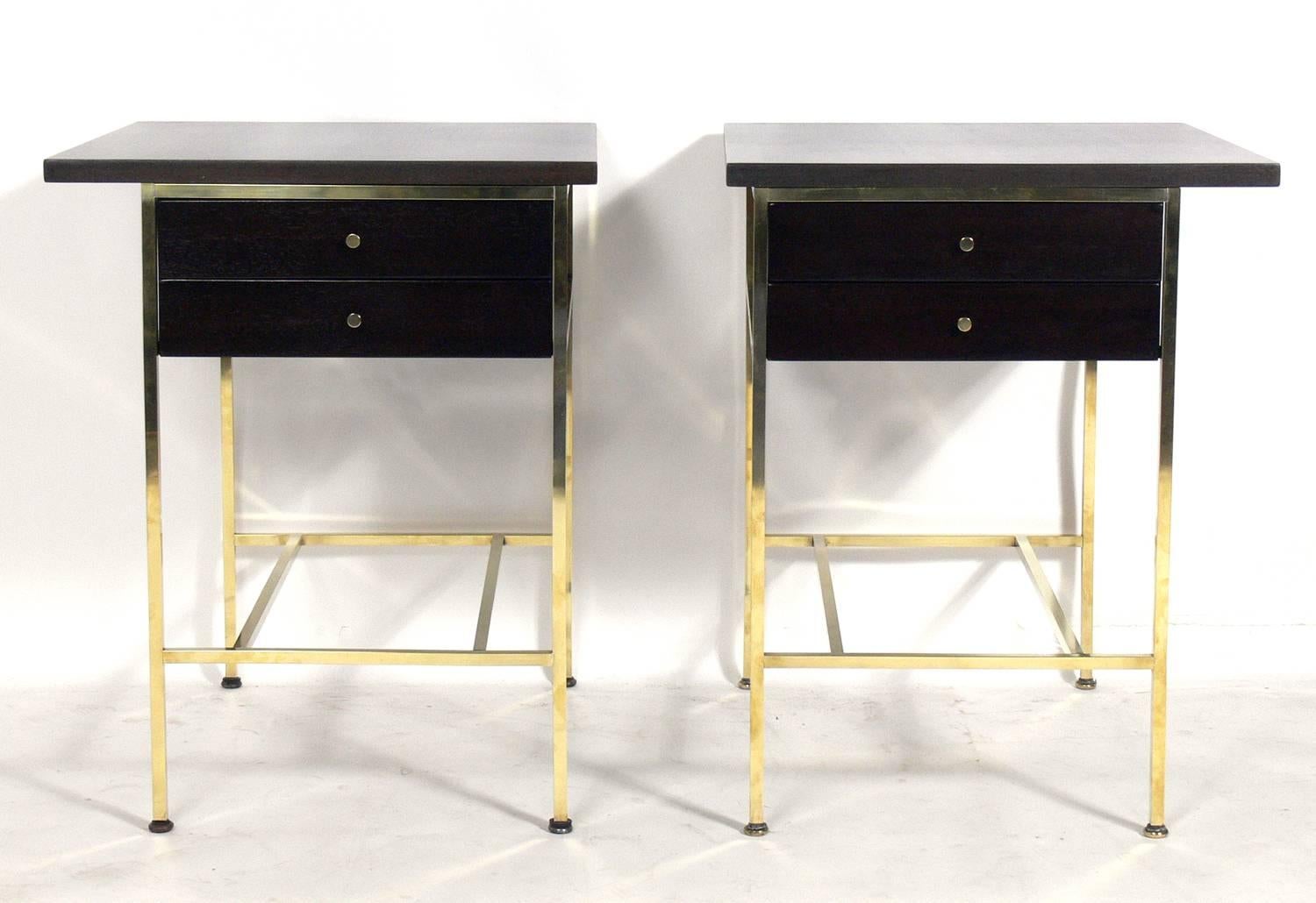 Pair of modern nightstands or end tables, designed by Paul McCobb for Calvin, American, circa 1950s. They have been completely restored in an ultra-deep brown finish with the brass elements hand polished and lacquered.