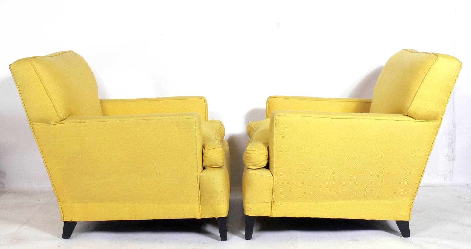 Pair of Mid-Century Modern lounge chairs, in the manner of Dunbar, American, circa 1950s. These chairs are currently being reupholstered and refinished and can be completed in your choice of finish color to the legs and in your fabric. The price