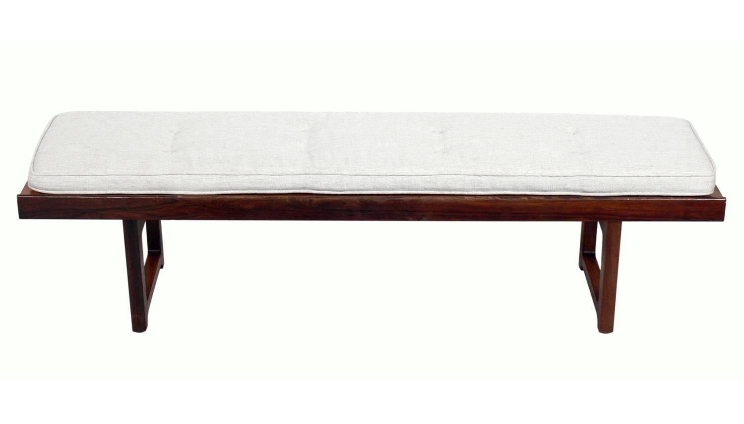 Danish modern rosewood bench or table, designed by Bruksbo, Norway, circa 1960s. It has been reupholstered in an ivory color fabric. Currently being refinished. Price noted below includes refinishing.