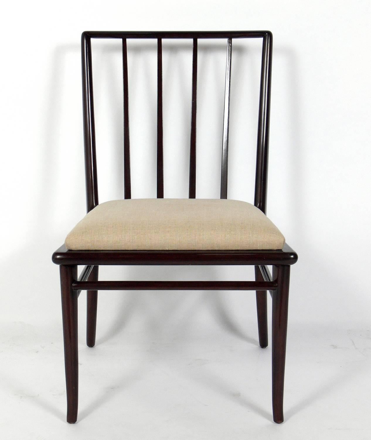Set of four dining chairs, designed by T.H. Robsjohn-Gibbings for Widdicomb, American, circa 1950s. They have been refinished in a deep brown and reupholstered in a sand colored linen type fabric. They would look great with any of the Robsjohn