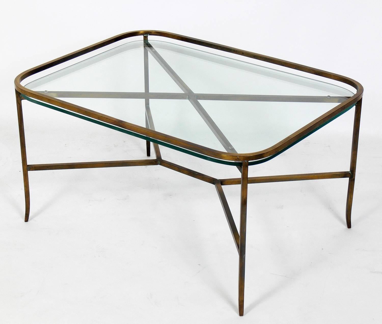 Elegant brass coffee table with inset glass top, American, circa 1950s. It is a very heavyweight quality piece. Retains it's warm original patina.