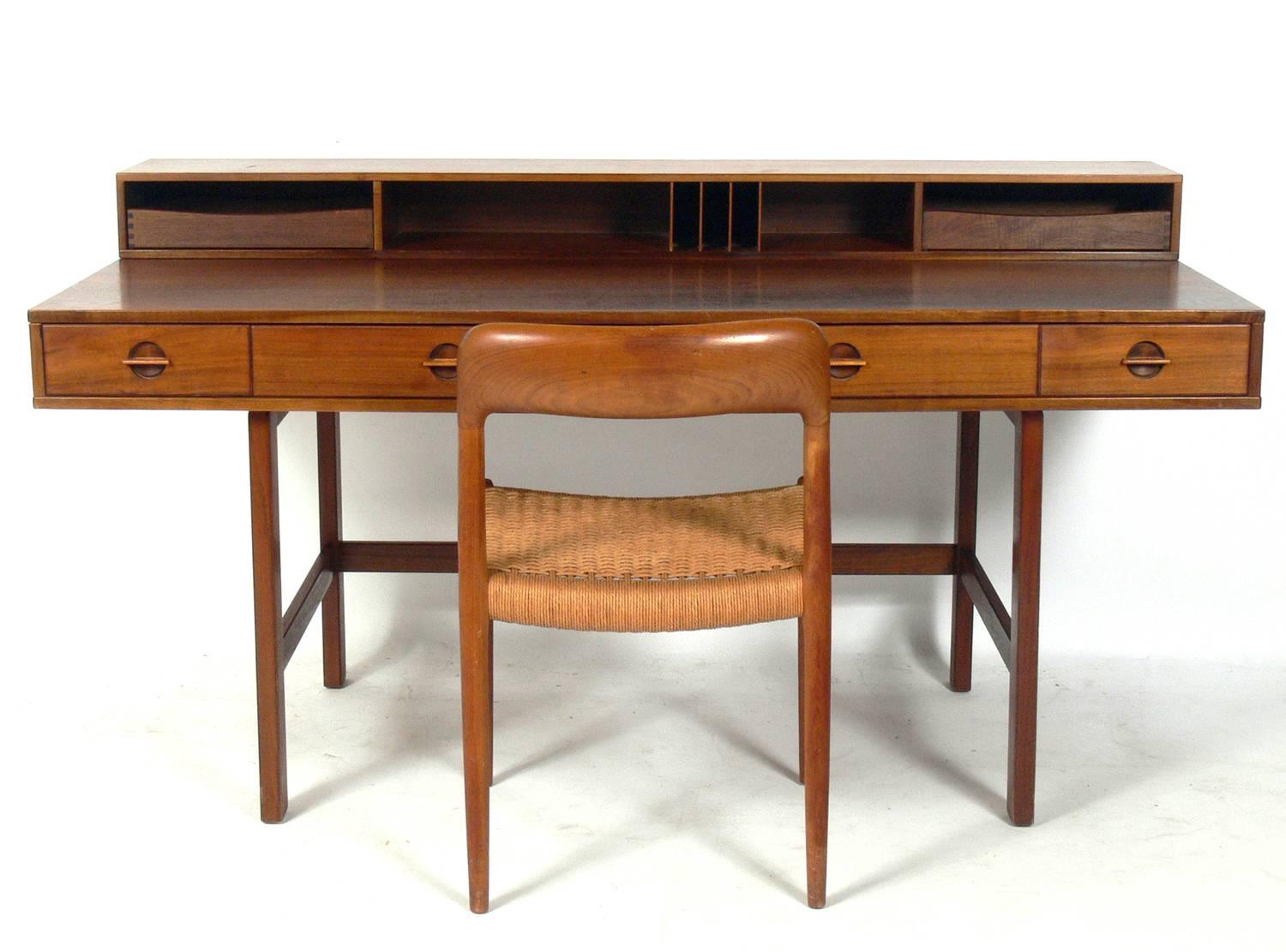Clean Lined Architectural Danish Modern Desk and Chair, Danish, circa 1960s. The flip top partner’s desk was designed by Jens Quistgaard for Peter Løvig Nielsen and the chair was designed by Niels Moller. The desk and chair have lived their entire