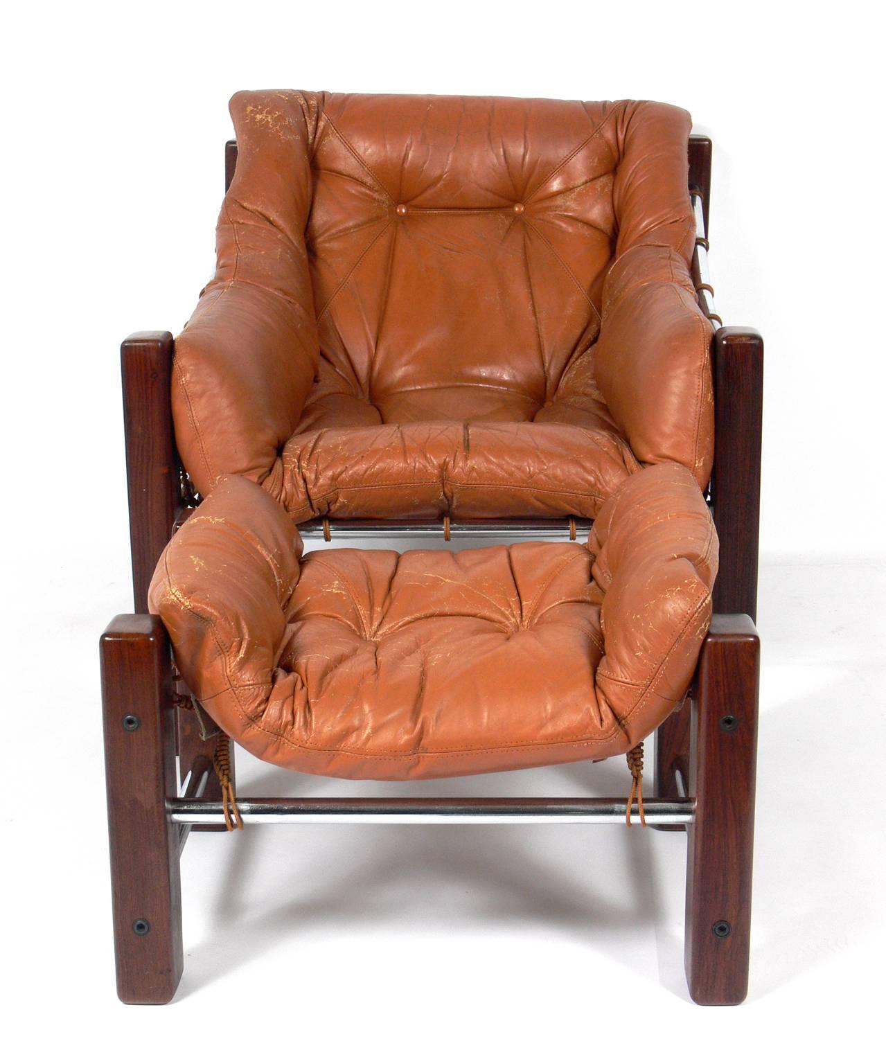 Exotic rosewood or jacaranda and leather Brazilian lounge chair and ottoman, designed by Jean Gillon for Italma Wood Art, Brazil, circa 1960s. It retains it's original leather upholstery, which is perfectly worn and broken in if you like aged