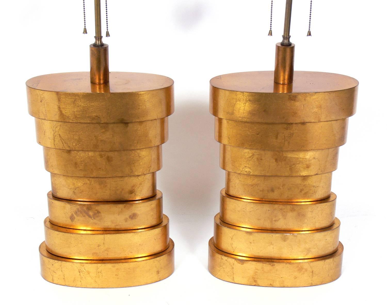 Large-scale gold leafed stacked lamps, American, circa 1950s. Very sculptural forms retaining wonderful original patina. They have been rewired and are ready to use. Price noted below includes shades.