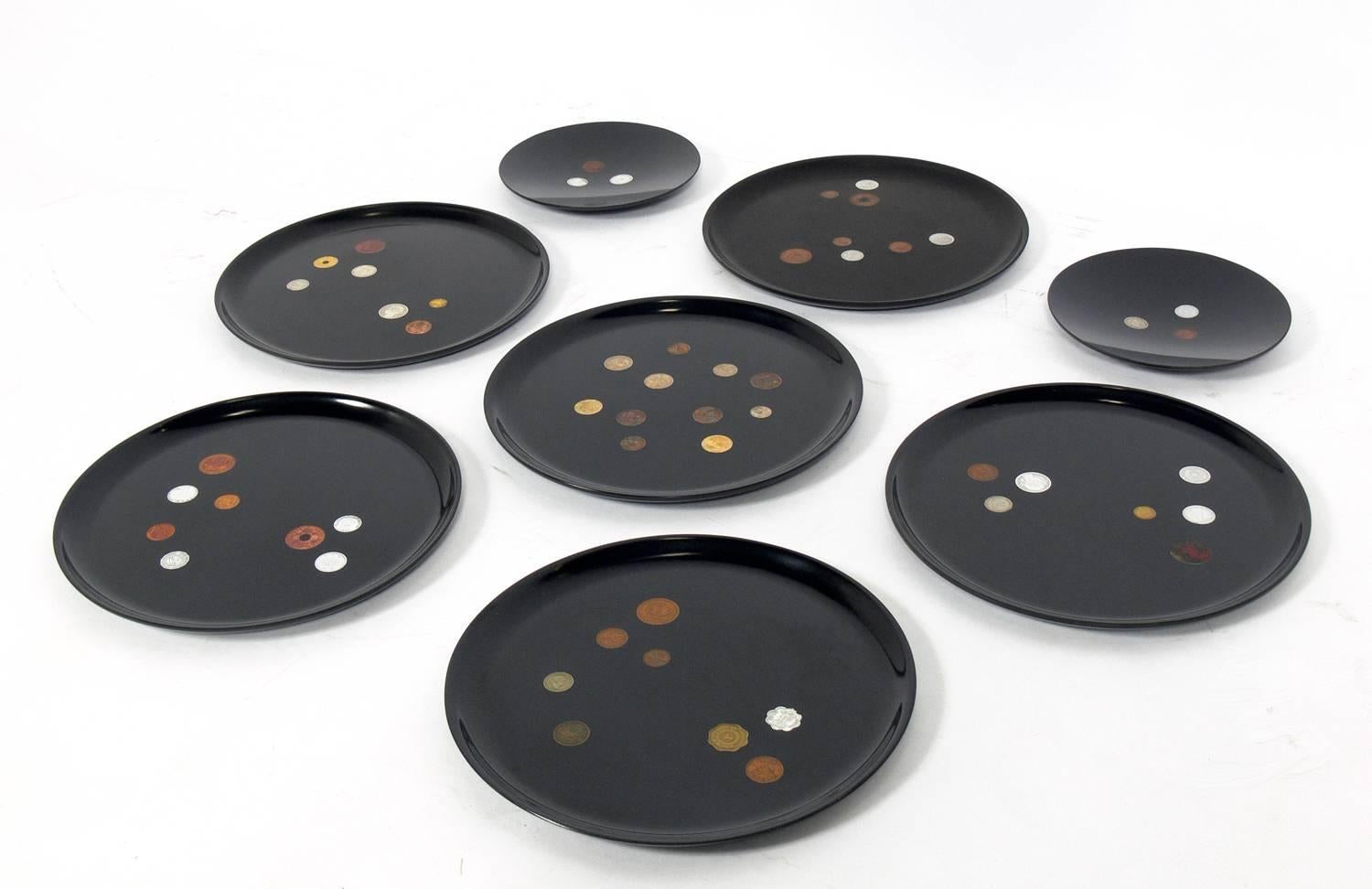 Group of coin inlaid trays, made by Couroc of Monterey California, American, circa 1950s. They have a very graphic look and work as entertaining trays, or even better grouped as a wall sculpture. Measures: The small trays measure 7