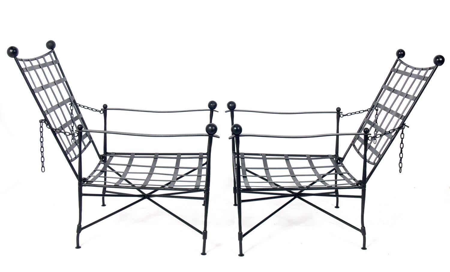 Pair of iron lounge chairs designed by Mario Papperzini for Salterini, Italian, circa 1950s. This is a versatile form and it can be used indoors or outdoors. This sculptural chair design was used by Yves Saint Laurent in his personal residence at la