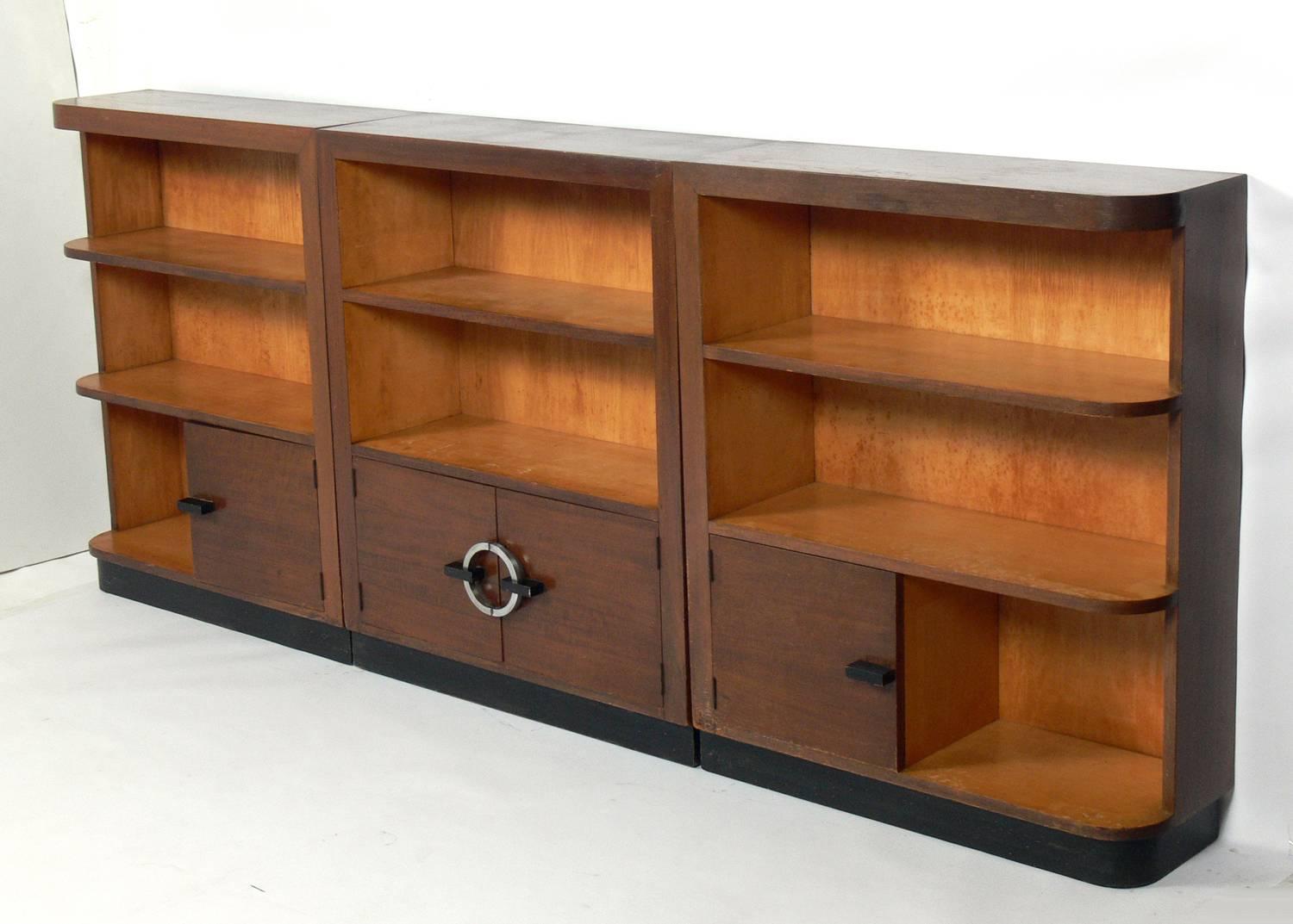 Group of streamlined Art Deco cabinets by gilbert Rhode for Herman Miller, circa 1930s. Constructed of exotic east India laurel and walnut. These cabinets are currently being refinished and will look incredible when completed. The price noted below