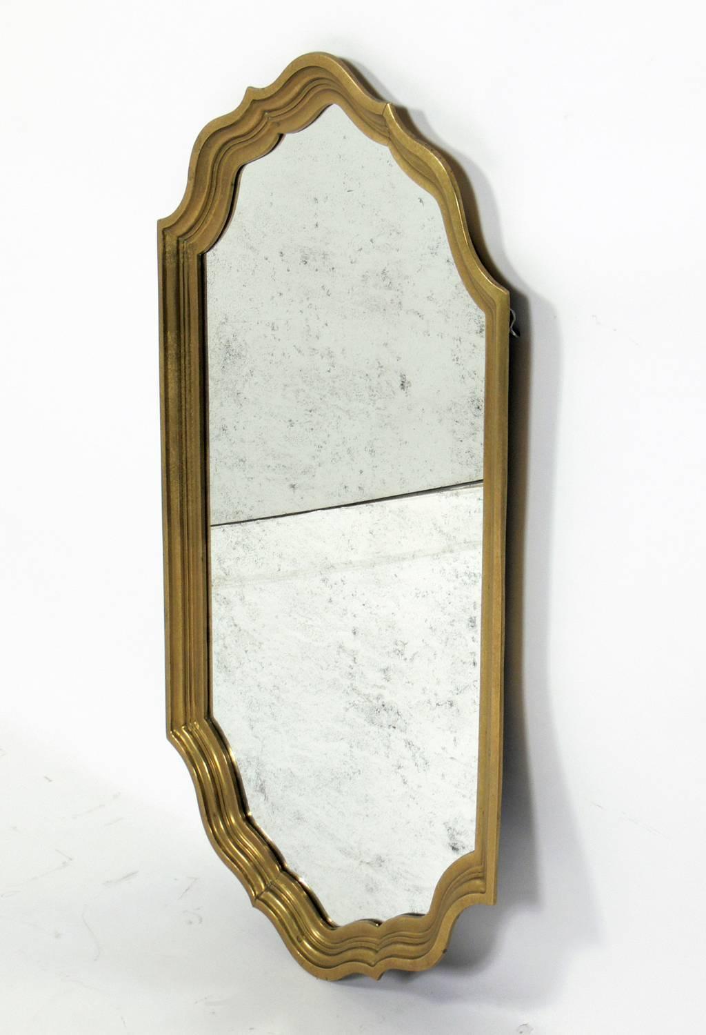 Elegant brass mirror, circa 1960s. Warm patina to both the brass frame and the mirrored glass.