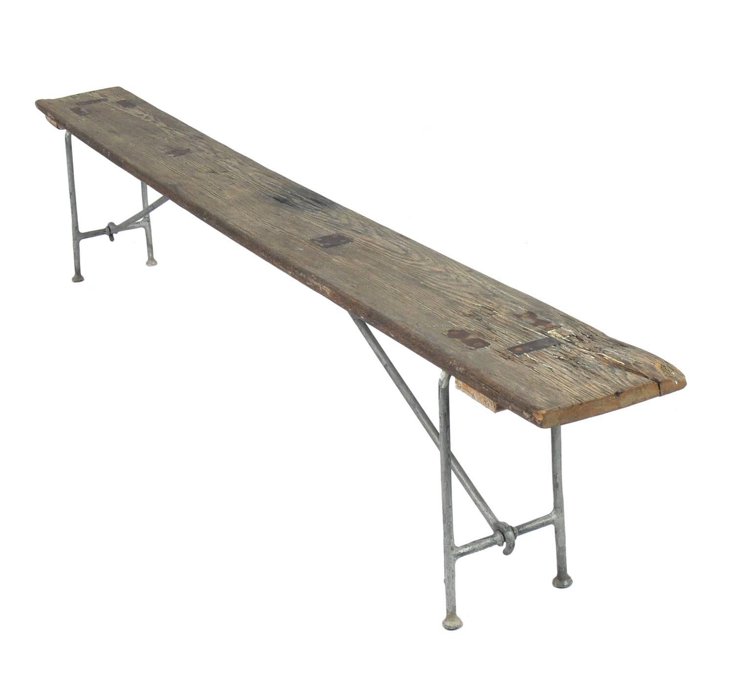 Nautical Campaign bench, American, circa 1930s. These benches were made for use on U.S. Navy ships in the 1930s. It is constructed of solid pine and galvanized metal. It easily folds down for flat storage. This example retains it's wonderful aged