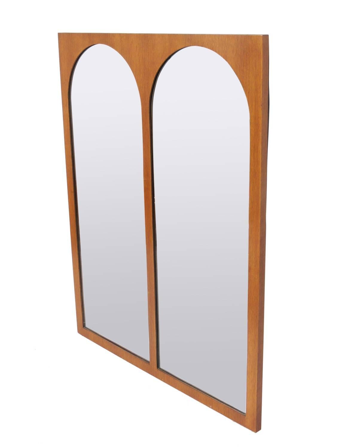 Arched walnut coliseum mirror, designed by T.H. Robsjohn Gibbings for Widdicomb, American, circa 1950s.