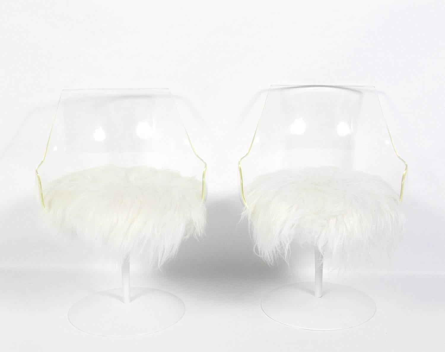 Pair of sculptural Lucite chairs, designed by Erwine and Estelle Laverne, American, circa 1960s. They have been repainted and reupholstered in soft long hair wool. The chairs swivel on the bases.