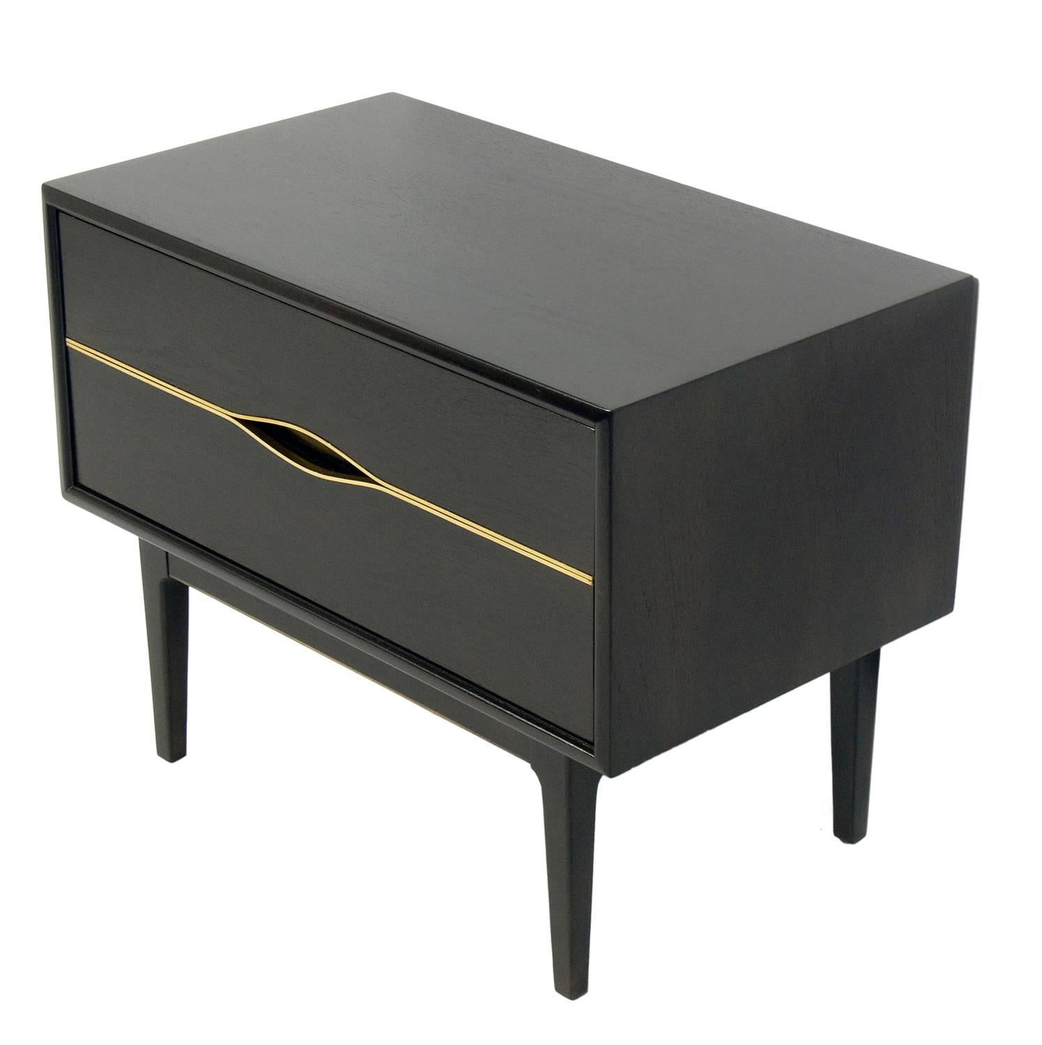 A pair of Ultra dark brown Mid-Century nightstand or side table with brass trim, American, circa 1960s. This piece has been refinished in an ultra deep brown color and the brass trim has been hand polished and lacquered.