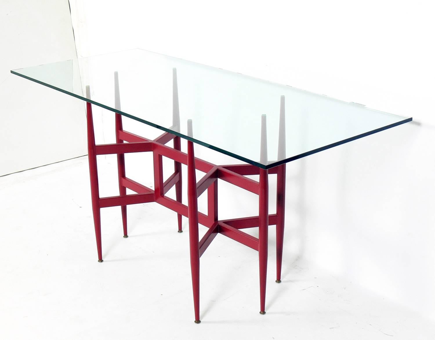 Sculptural Italian Mid-Century console table, Italy, circa 1950s. It has been repainted at some point in a deep red color. It is a versatile size and can be used as a console table, desk, or bar.