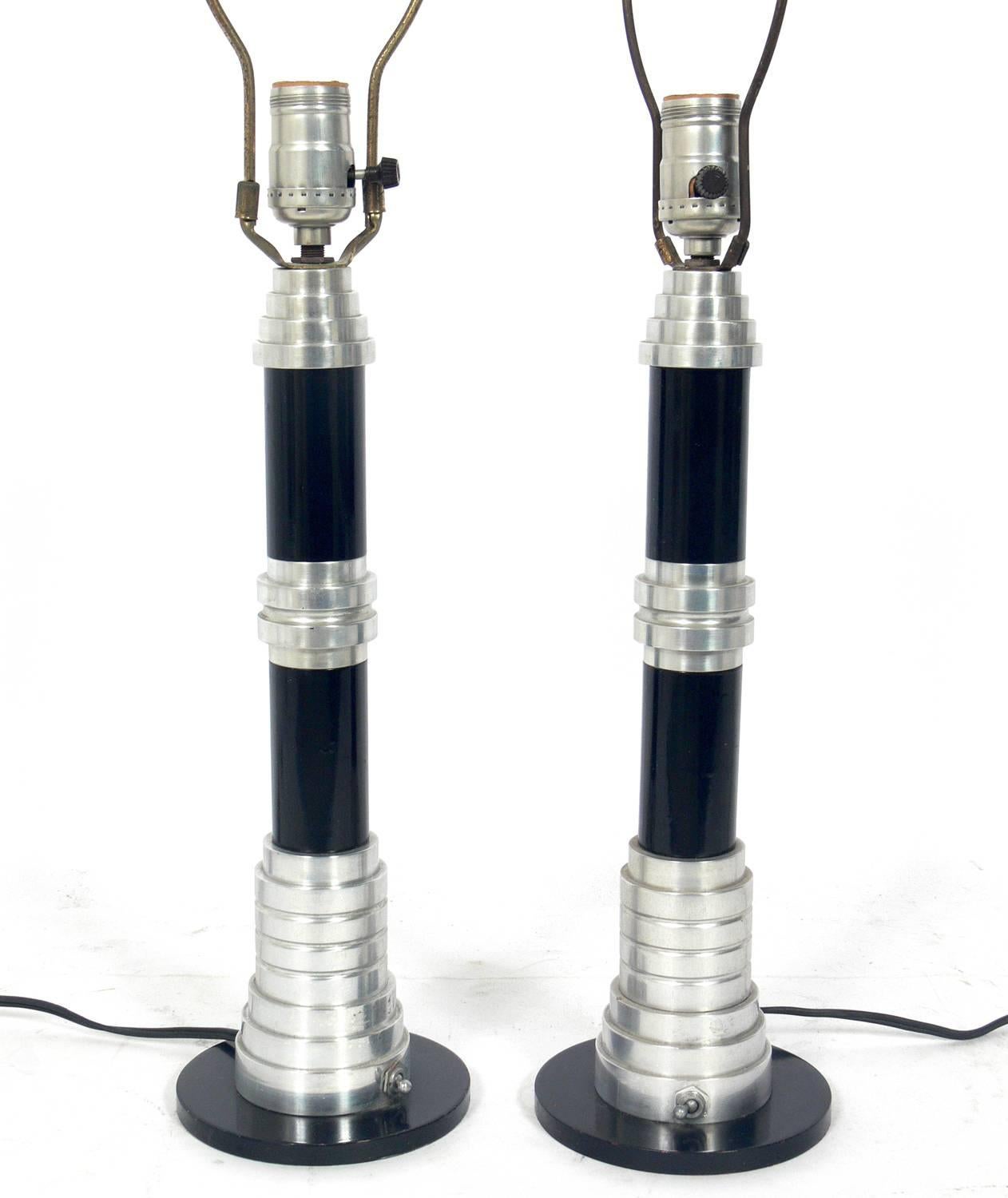 Pair of streamlined Art Deco lamps, by The Speedway Company, American, circa 1930s. They are signed on the underside of the base, “SPEEDWAY 2479 FLETCHER DRIVE L.A. 26 PAT. PEND.” They have been rewired. The price noted below includes the shades.