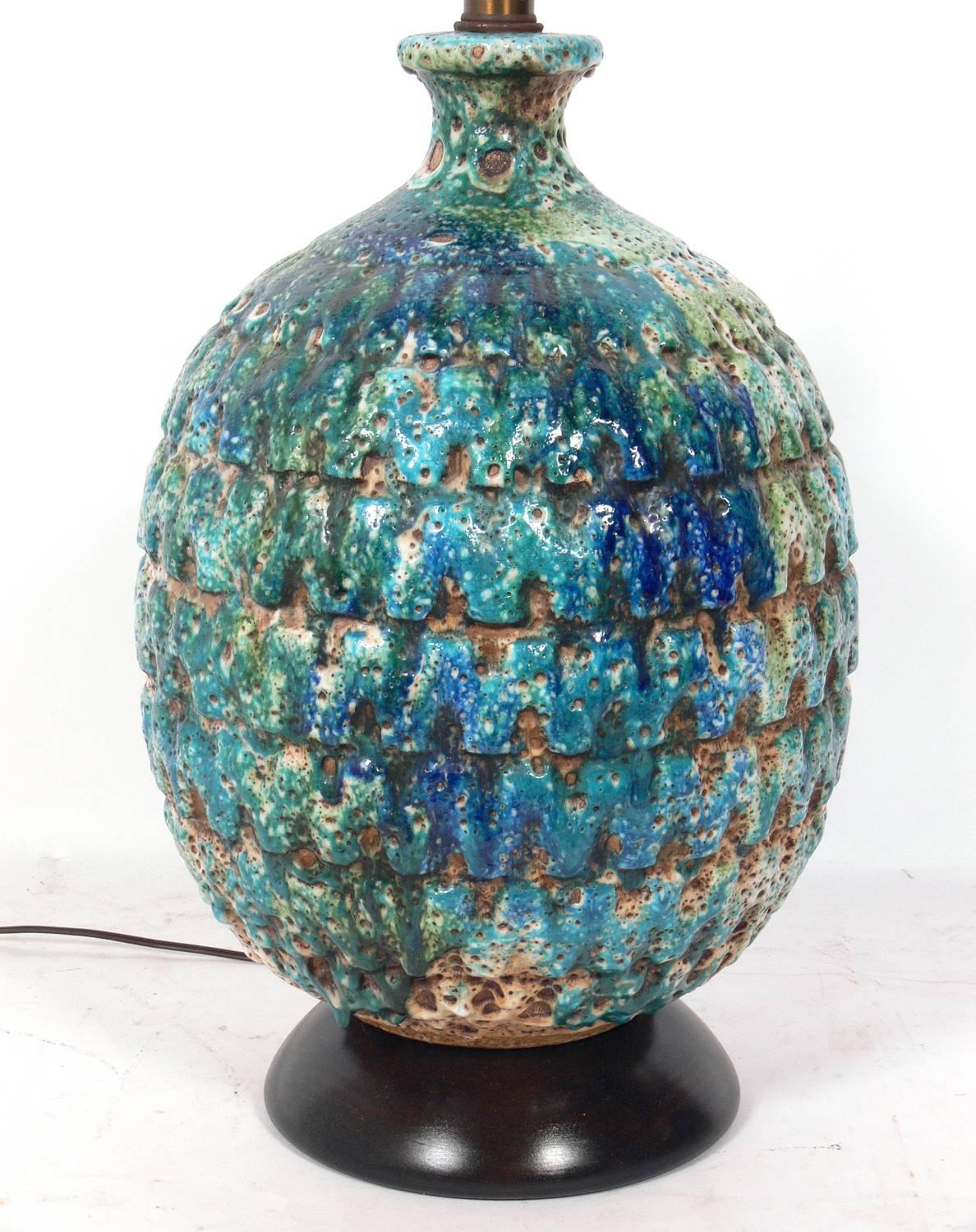 Large-scale Italian pottery lamp in vibrant blue greens, Italy, circa 1950s. These colors were popularized by Bitossi, but we are unsure of the manufacturer of this lamp. Wood base refinished in an ultra deep brown. Rewired.