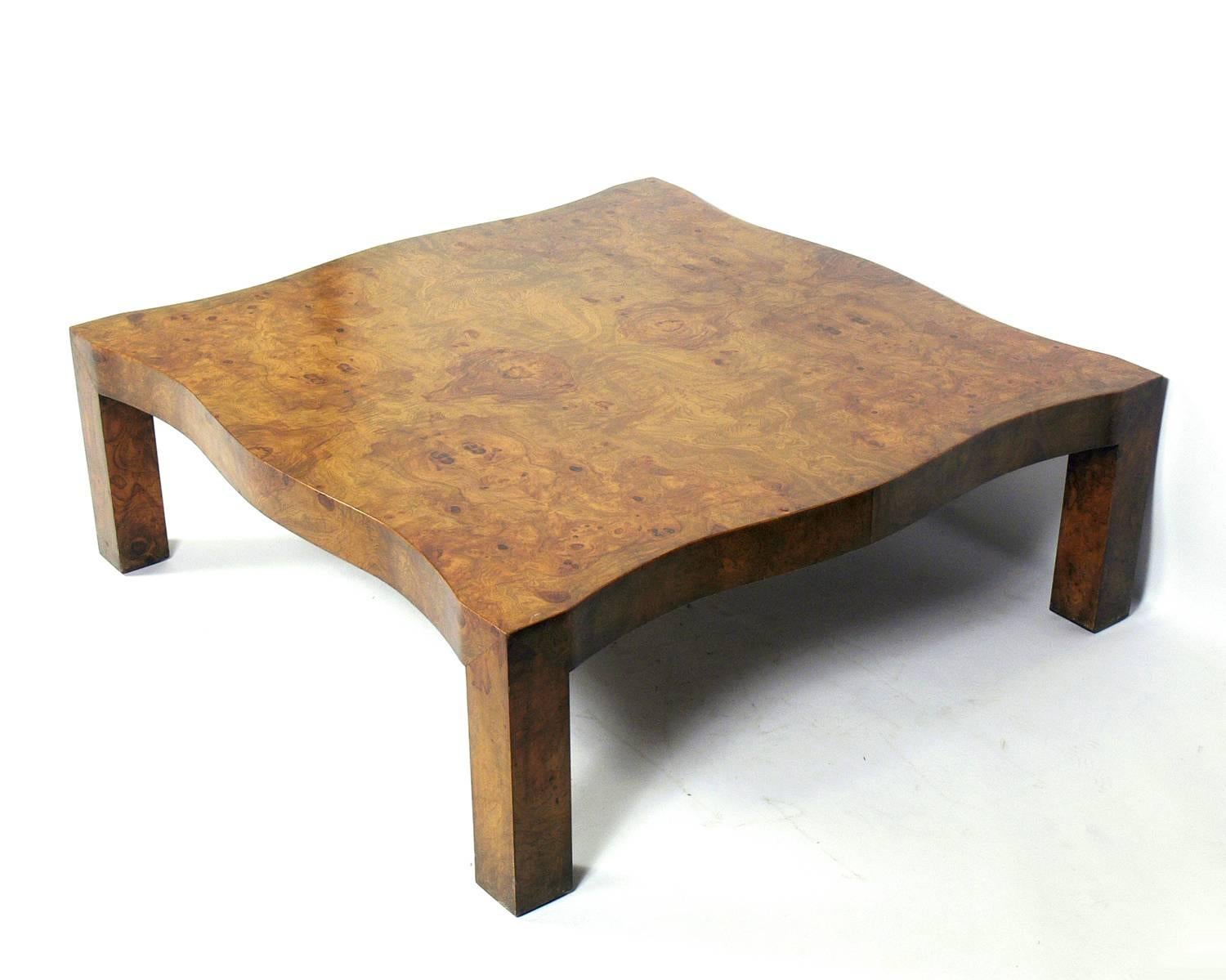 Large-scale burl wood coffee table in the manner of Samuel Marx, American, circa 1950s. Exhibits an elegant scalloped form with beautiful burl wood graining.