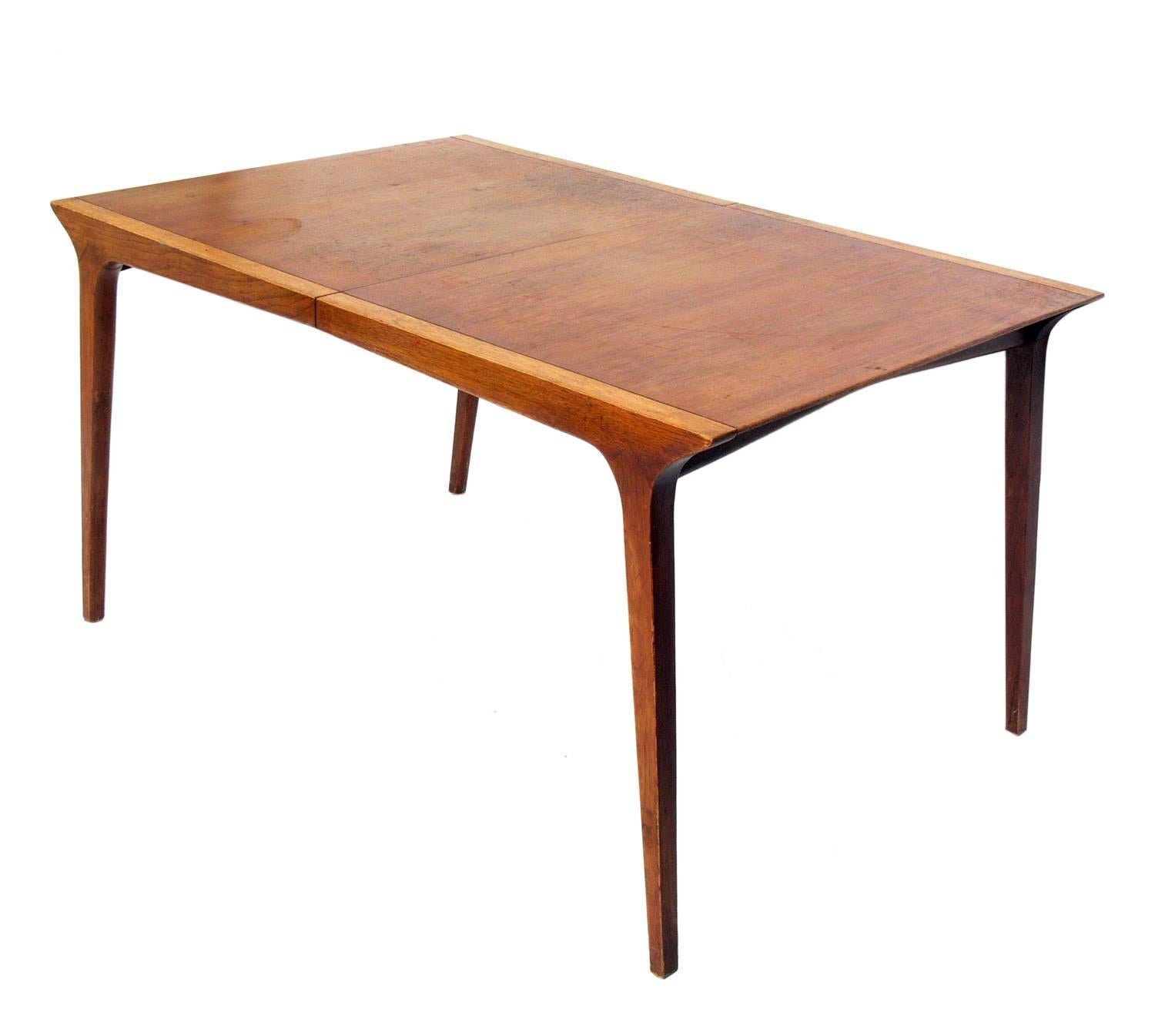Mid-Century Modern dining table, designed by John Van Koert for Drexel, American, circa 1950s. This table is currently being refinished and can be completed in your choice of finish color. The price noted below INCLUDES refinishing. The table