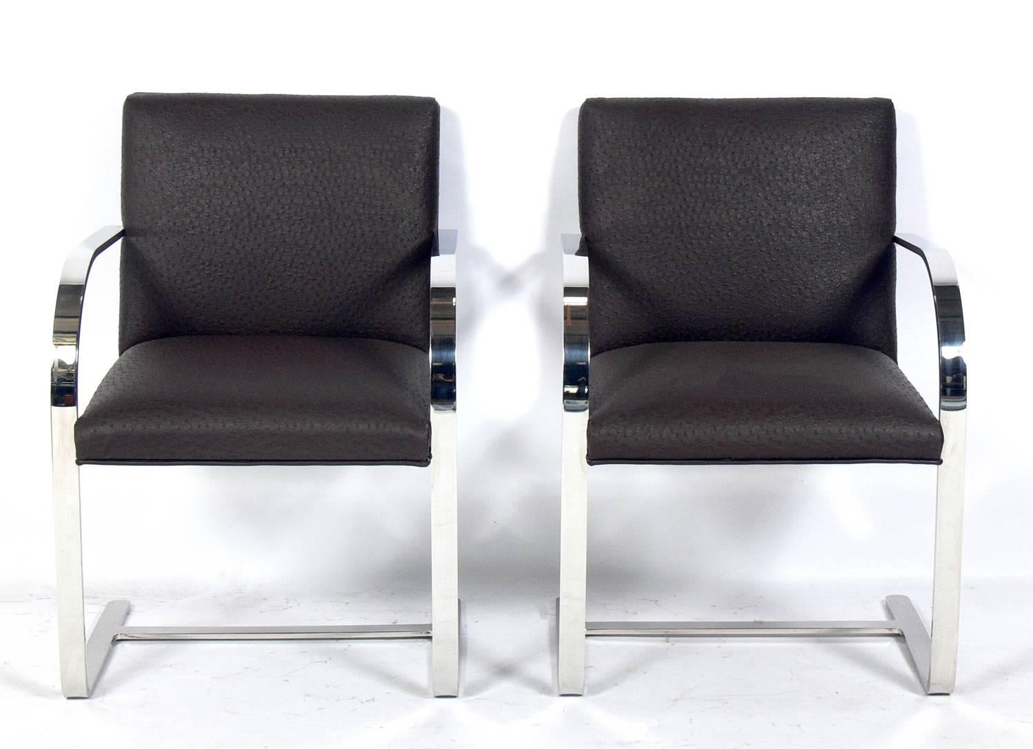 Set of four Brno chrome dining chairs after Mies van der Rohe, American, circa 1970s. These chairs are currently being reupholstered and can be completed in your fabric. The price noted below includes upholstery in your fabric.